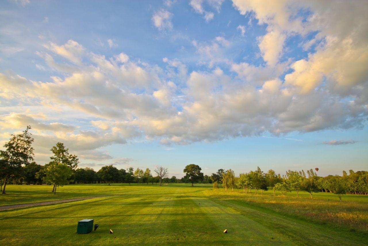 A well maintained fairway sunder cloudy skies