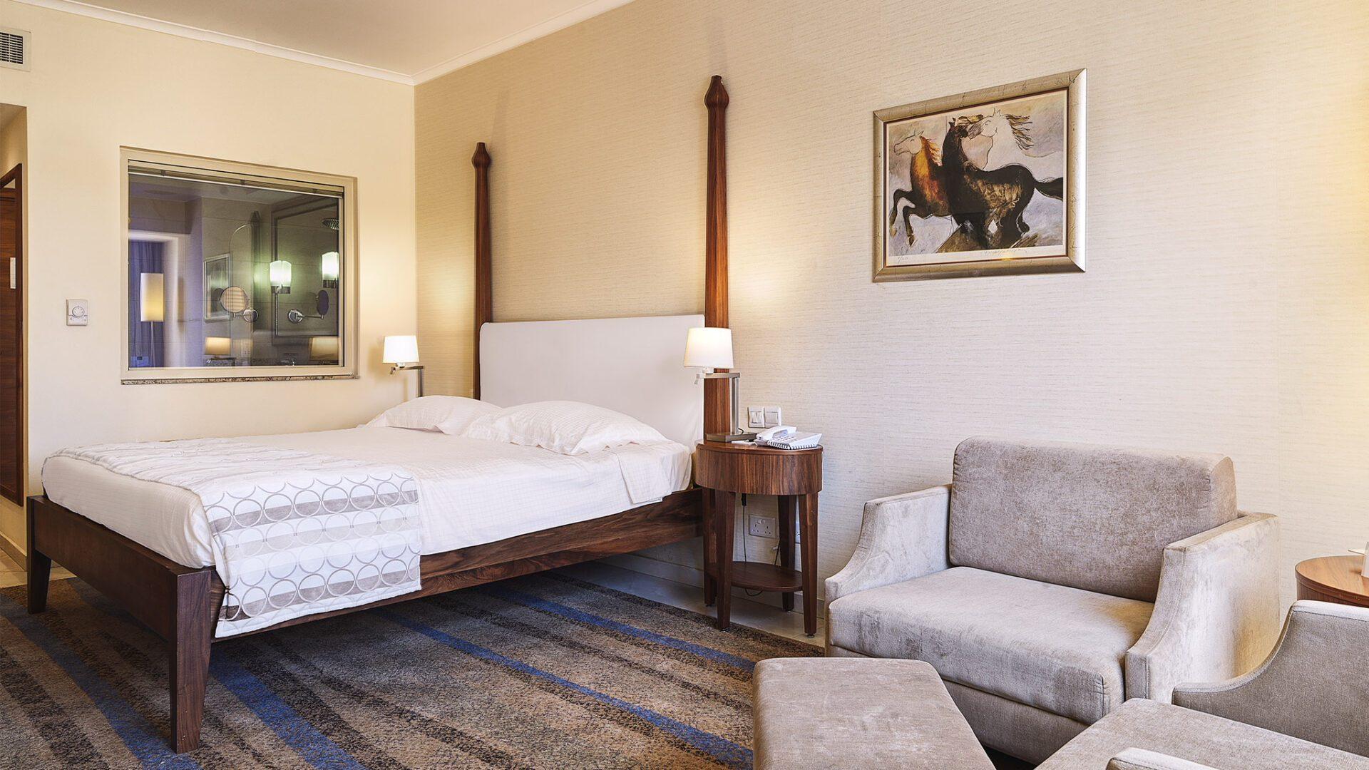 Double bed suite with a lounging area at Alexander The Great Beach Hotel