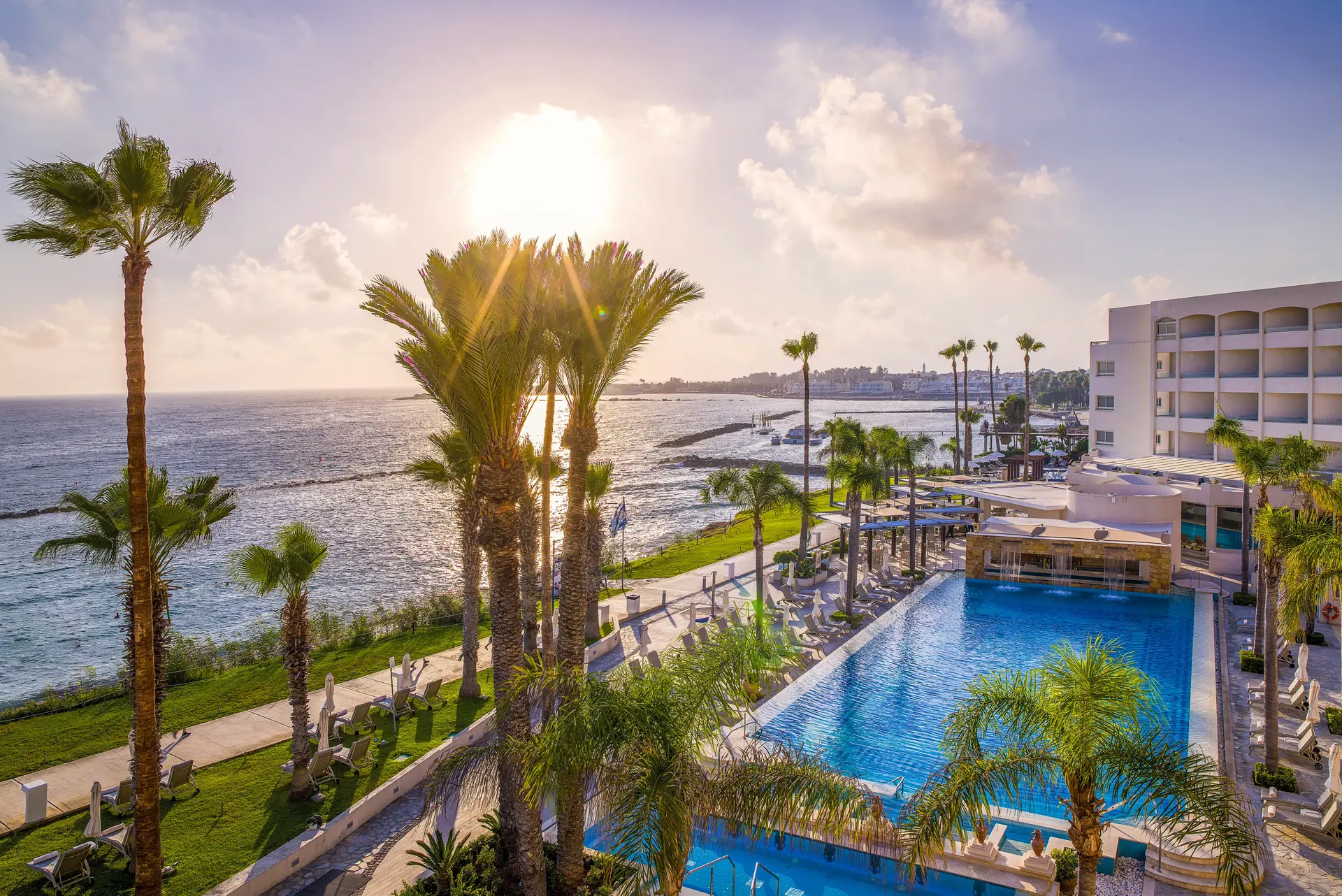 Overhead view of the outdoor swimming pool at Alexander The Great Beach Hotel with coastal views