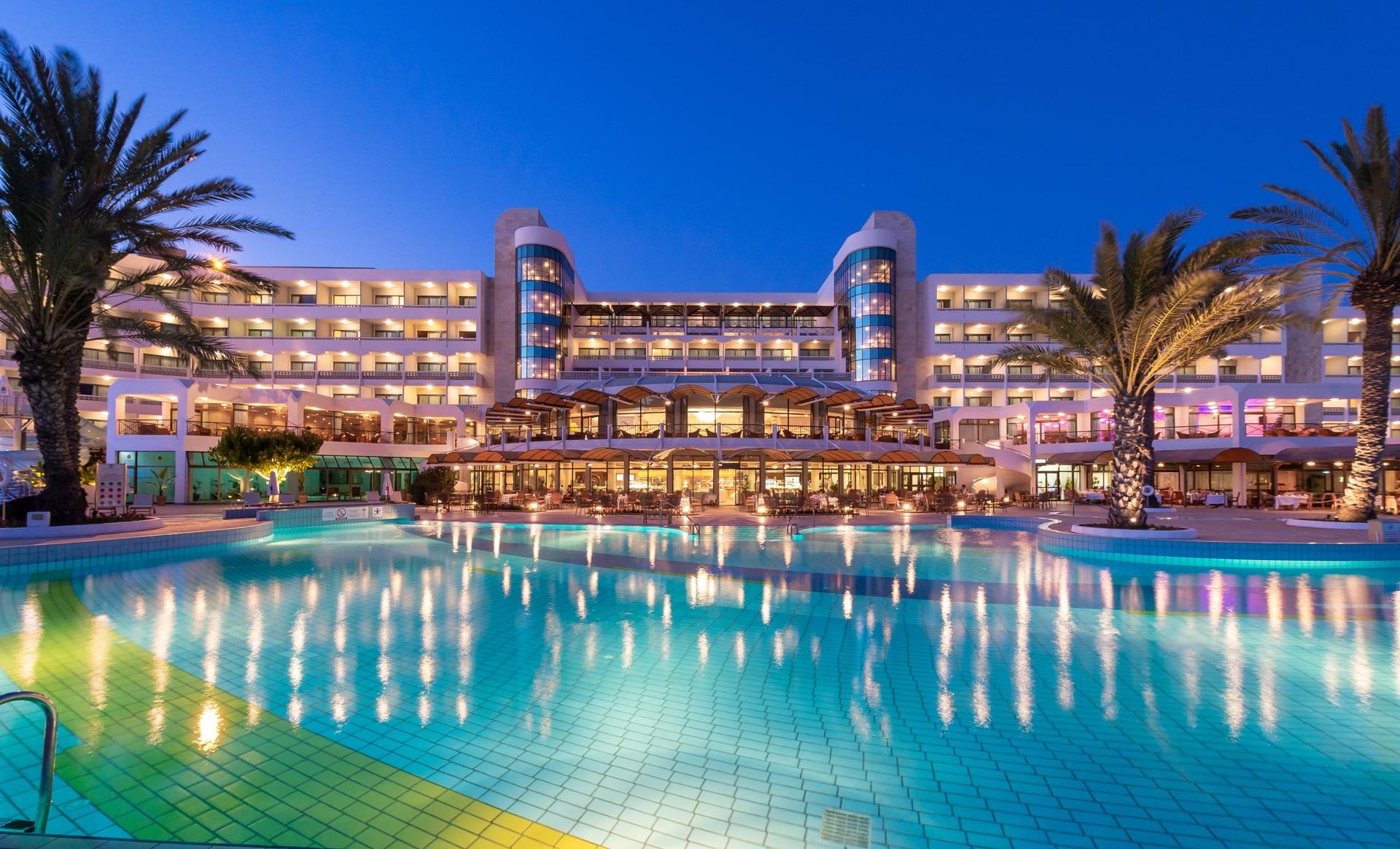 Panoramic view of Athena Beach overlooking the outdoor pool at night