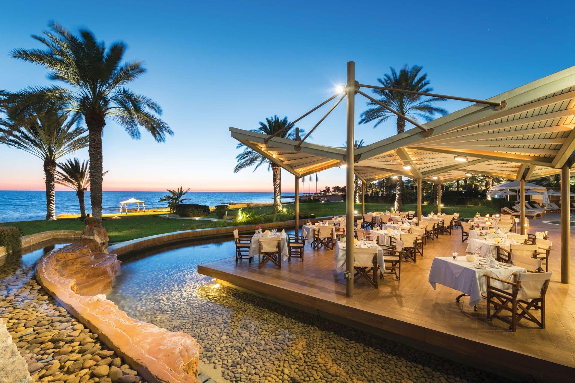Outdoor dining with coastal views at Athena Beach