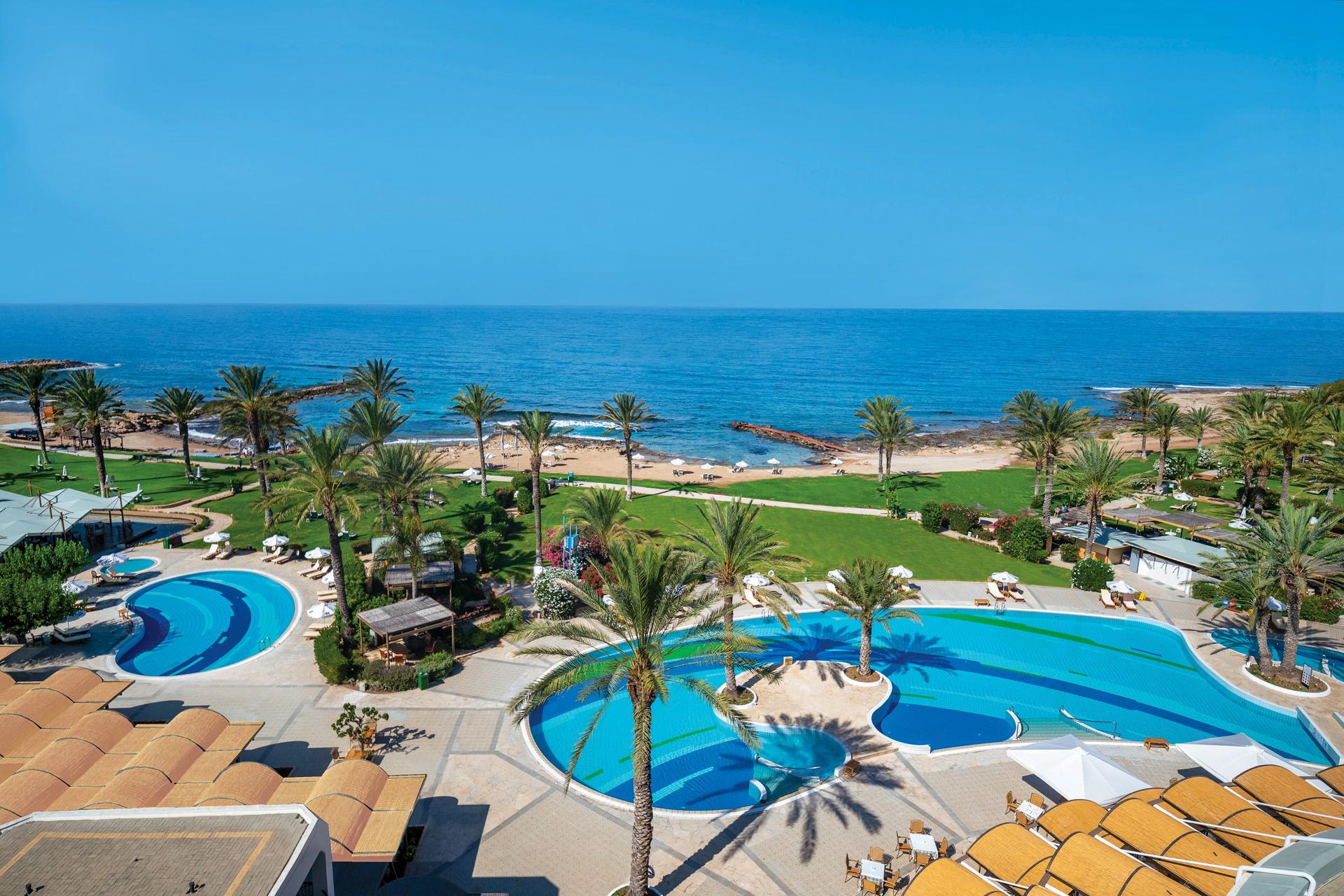 Overhead view of the outdoor swimming pool with coastal views at Athena Beach