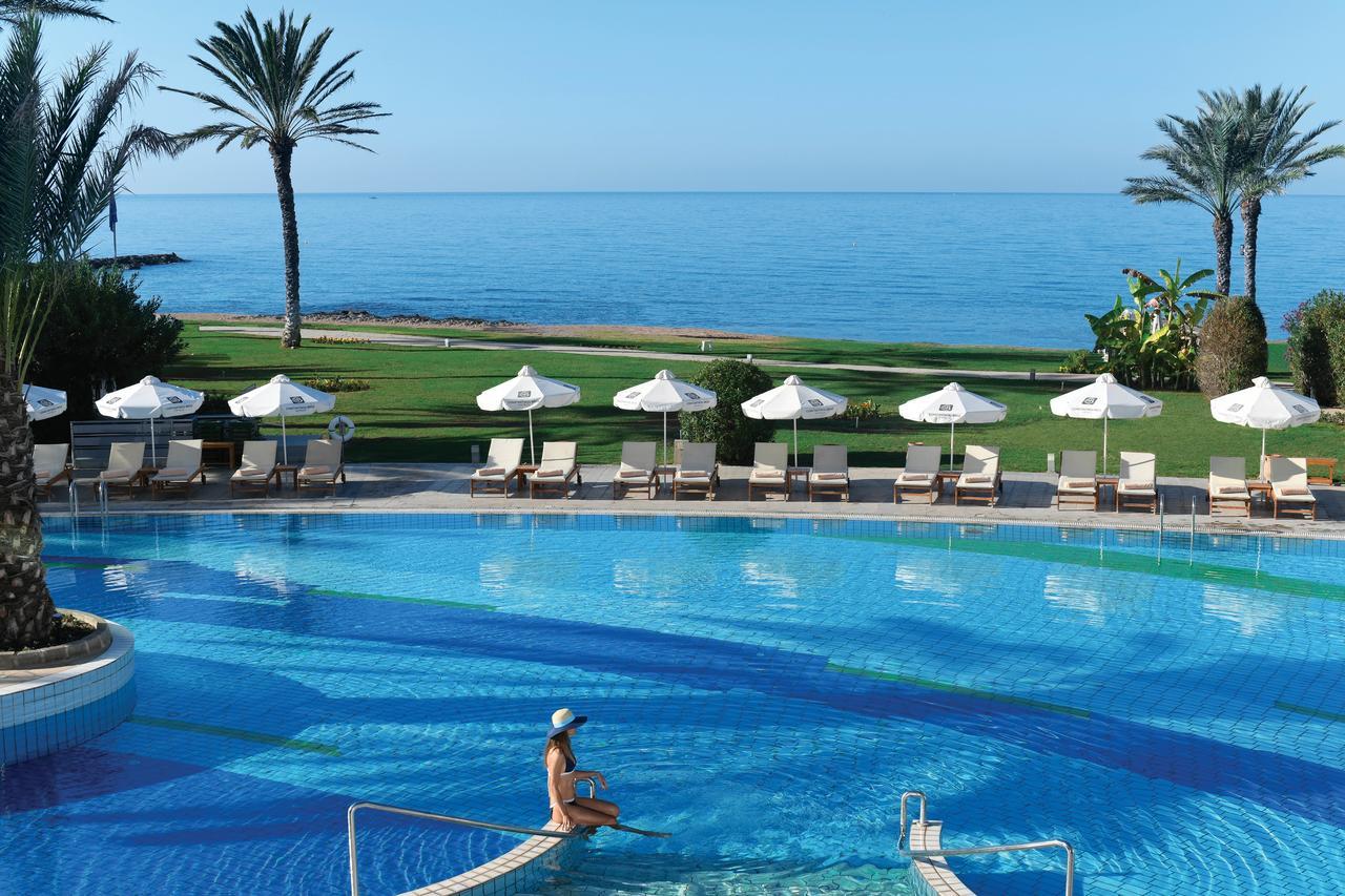 Overhead view of the outdoor swimming pool with coastal views at Athena Beach