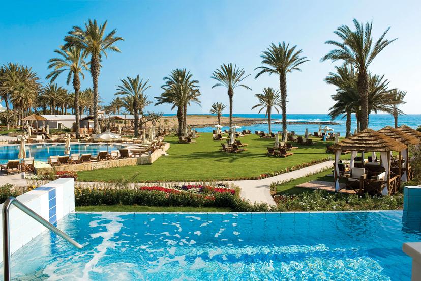 Panoramic view of the outdoor swimming pool, palm trees and the beach