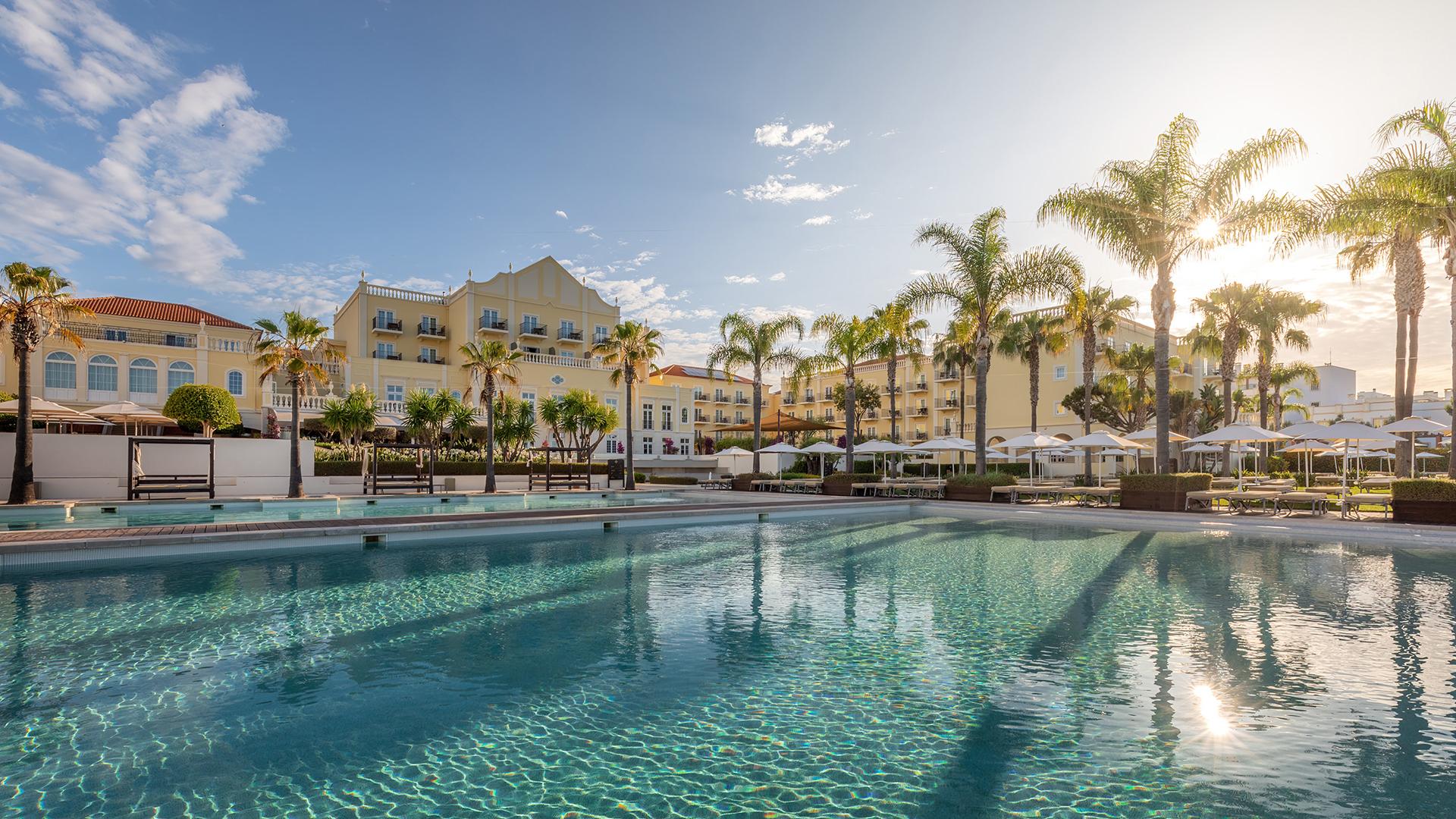 Panoramic view of the outdoor swimming pool at Domes Lake Algarve, Autograph Collection