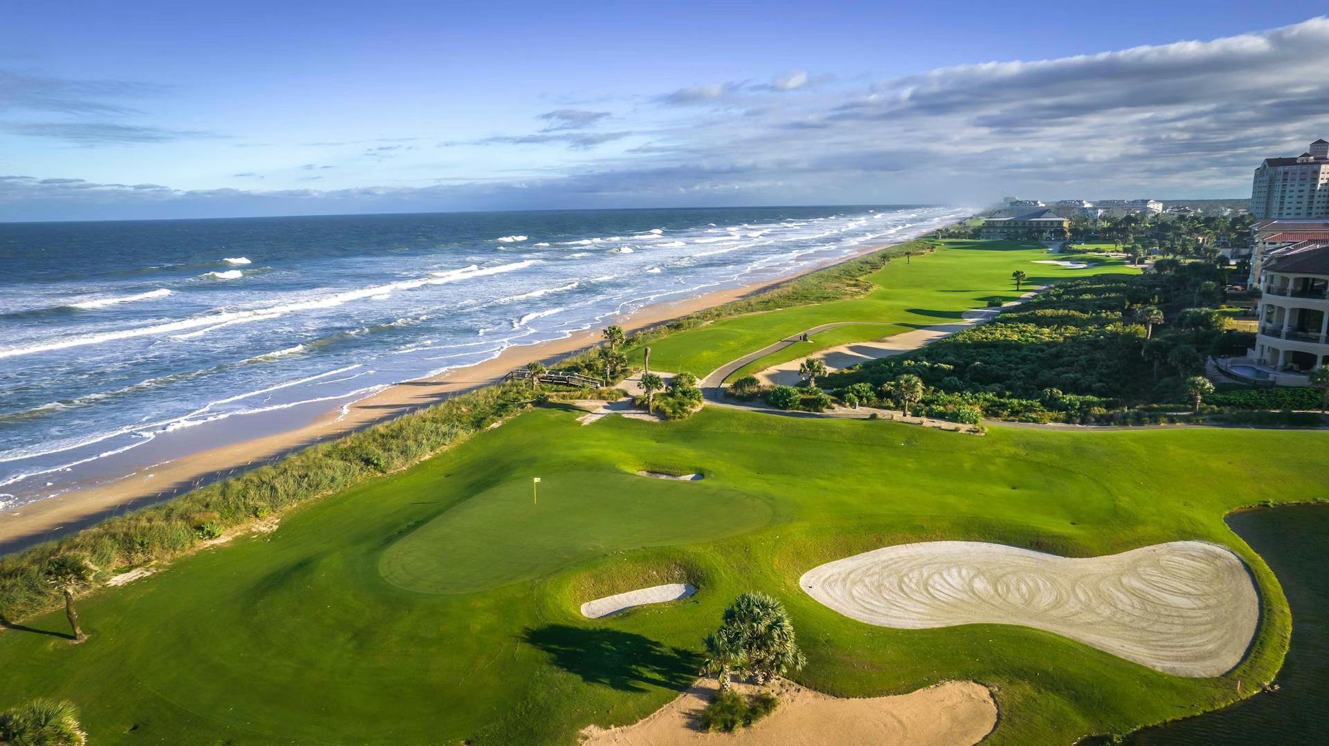 A smooth coastal green surrounded by sand bunkers