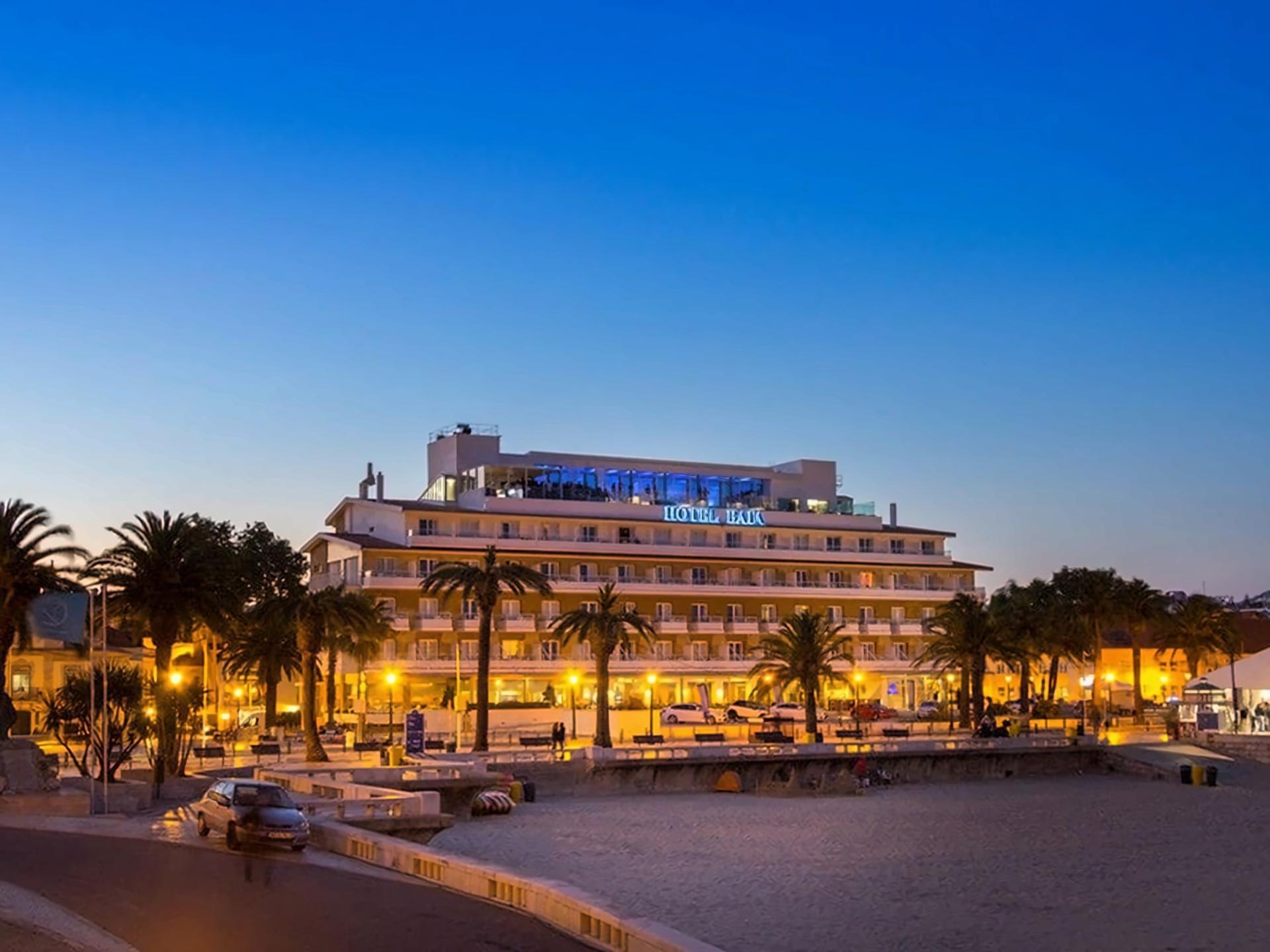 Panoramic view of Hotel Baia lit up at evening