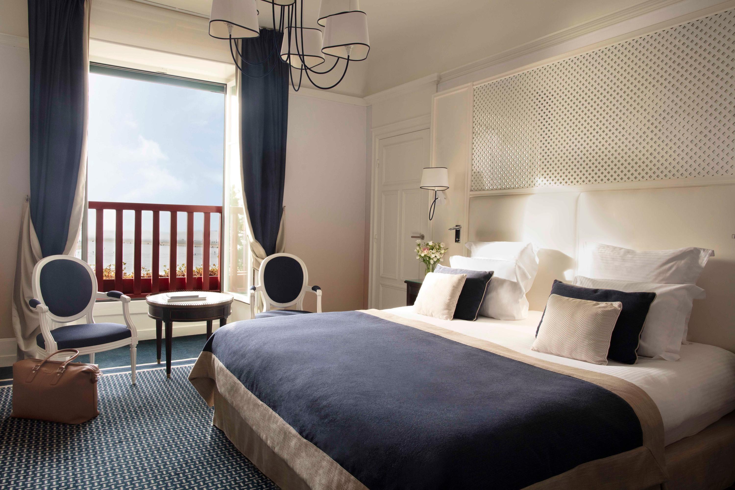 Luxurious double bed suite at Hotel Barriere L'Hermitage La Baule with balcony views of the beach