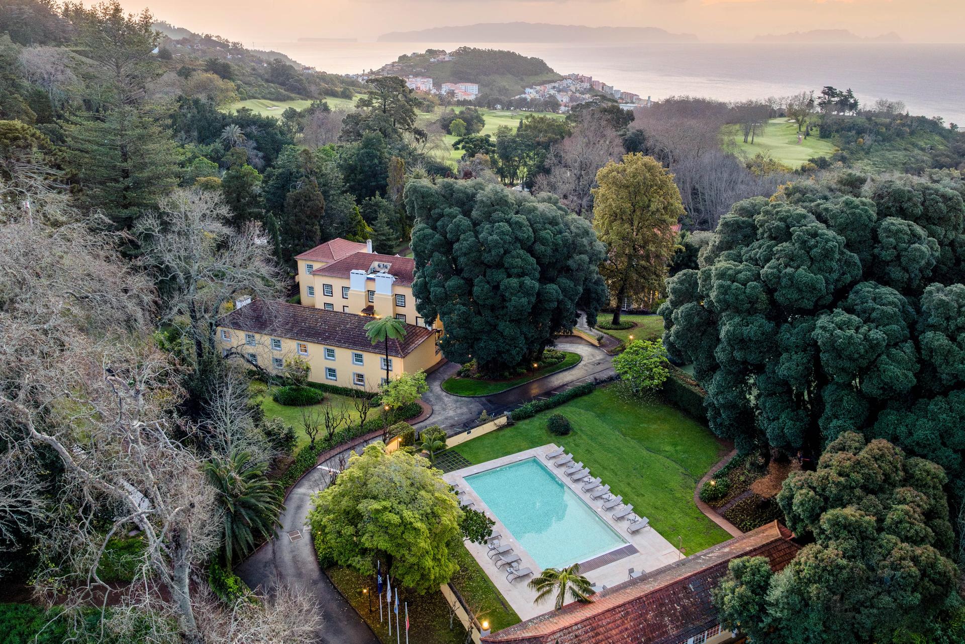 Overhead view of the Hotel Casa Velha do Palheiro - Relais & Chateaux building and outdoor swimming pool