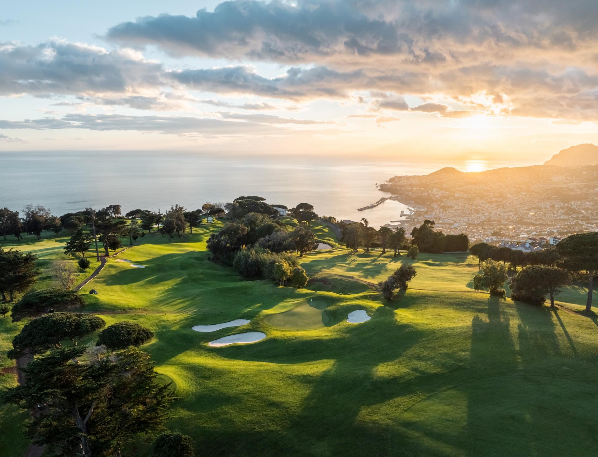 Overhead view of the sun setting over the Hotel Casa Velha do Palheiro - Relais & Chateaux golf course