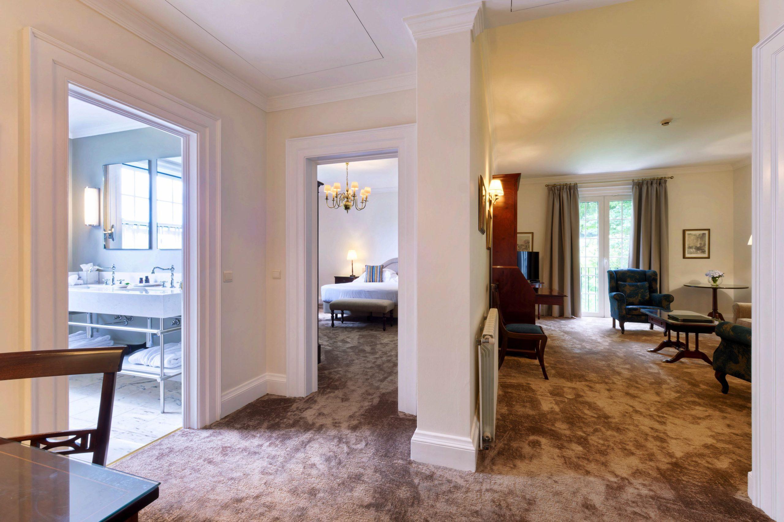 Spacious suite at Hotel Casa Velha do Palheiro - Relais & Chateaux with a separate living room bed room and bathroom