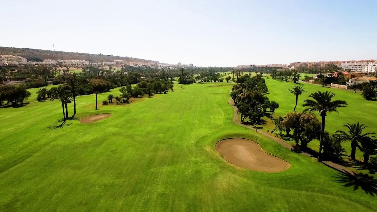 A well maintained fairway under clear blue skies