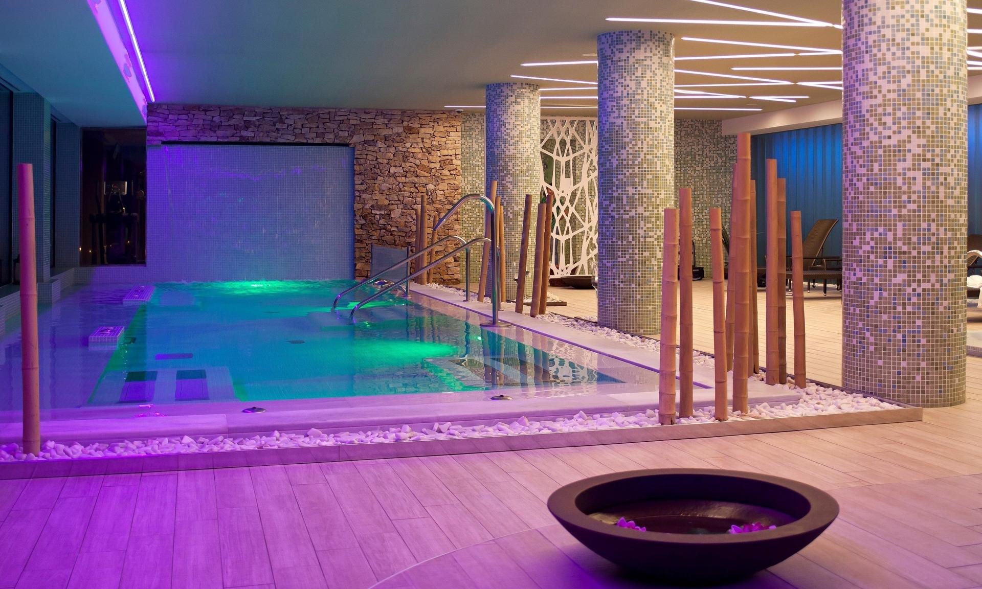 Indoor swimming pool with purple lights at Hotel Golf Almerimar