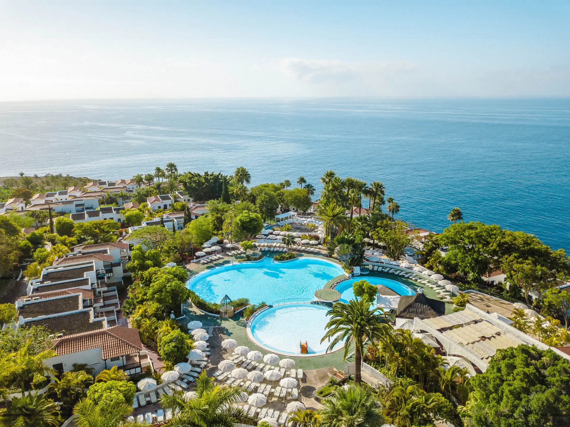 Overhead view of the outdoor swimming pool with coastal views at Hotel Jardin Tecina