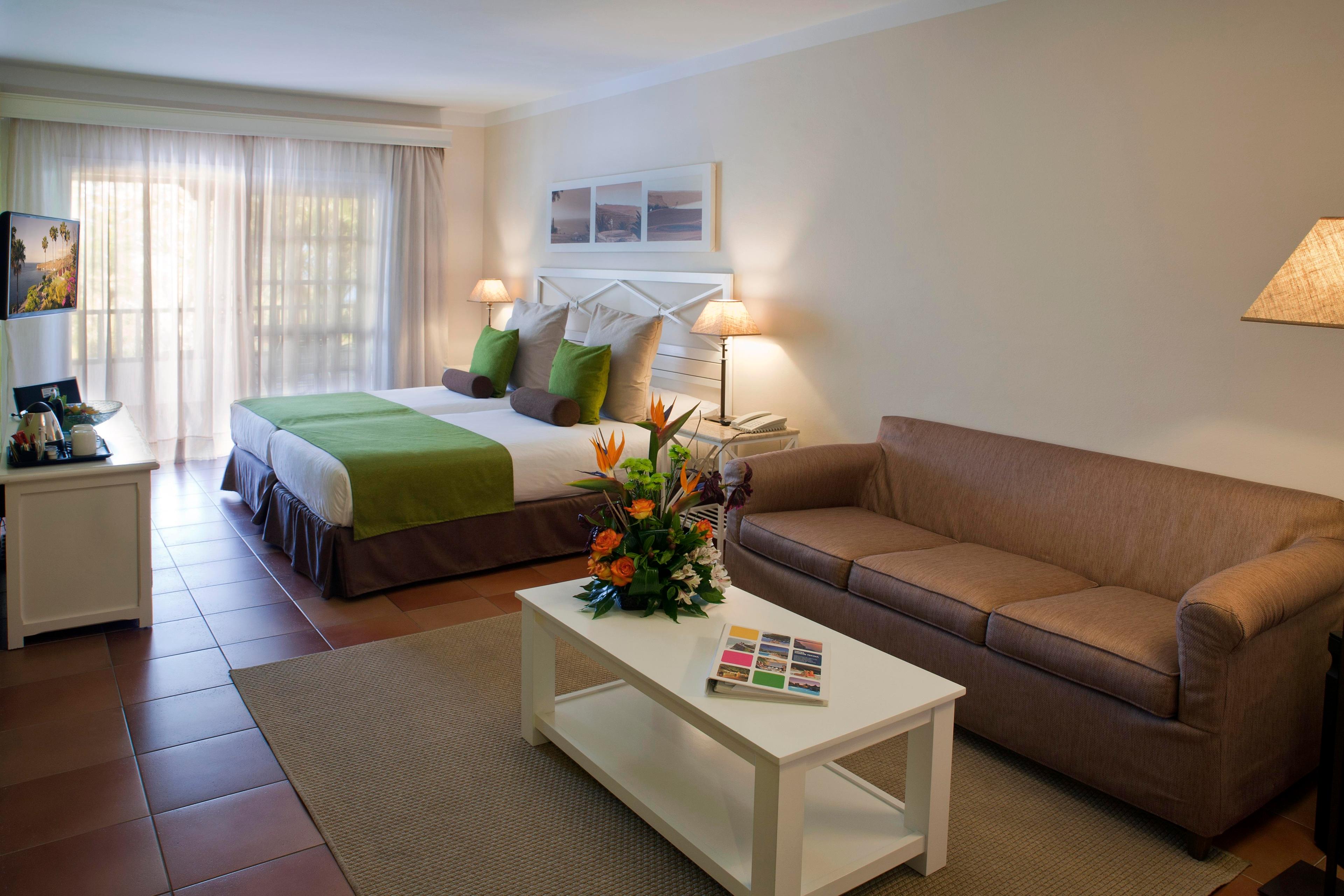 Spacious double bed suite with a balcony and lounging area