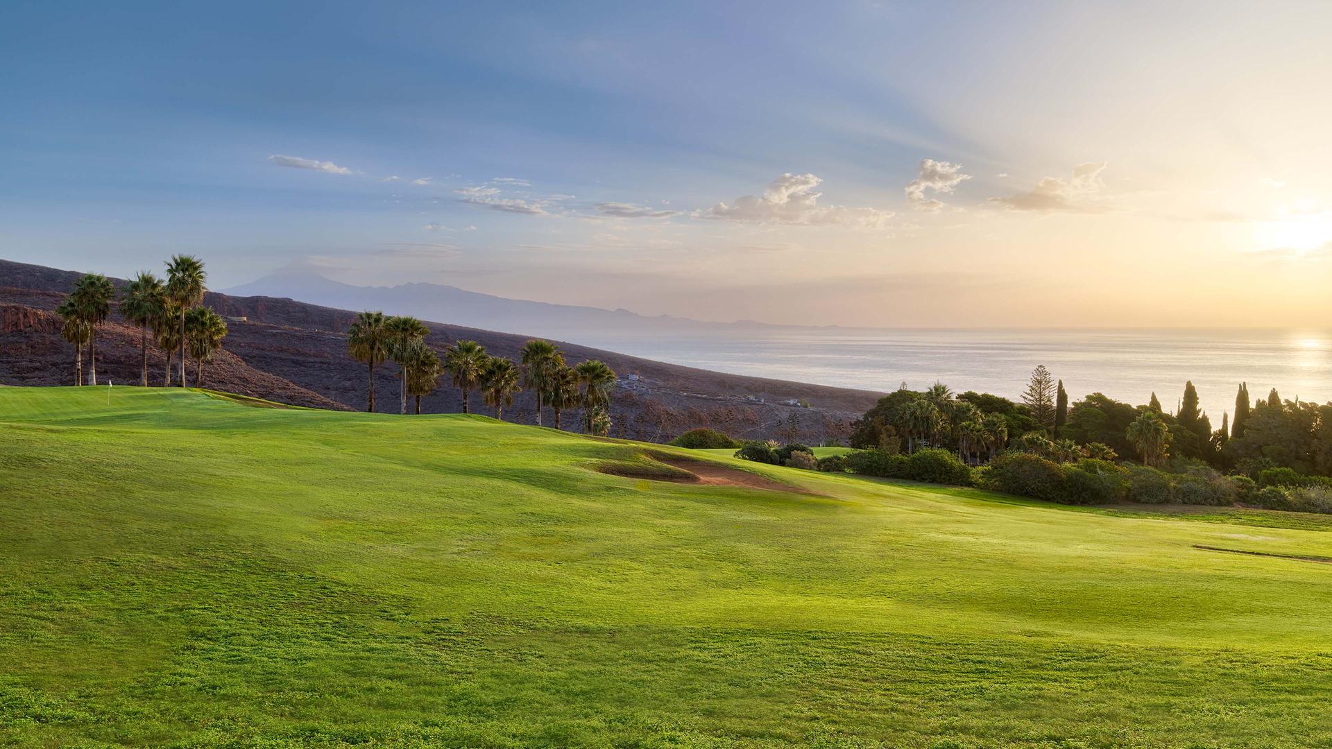 A well maintained fairway nestled with sand bunkers