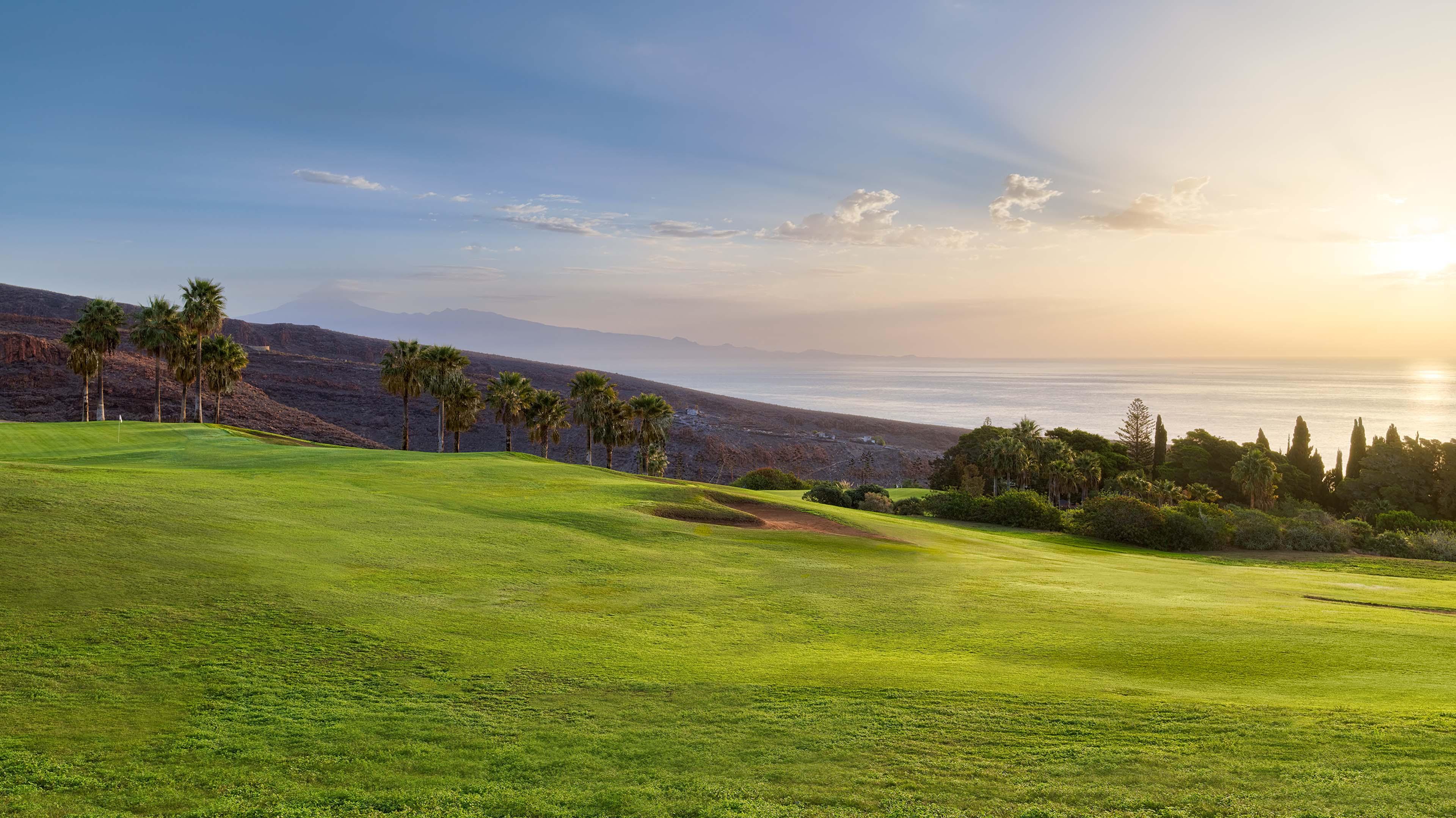 A well maintained fairway nestled with sand bunkers
