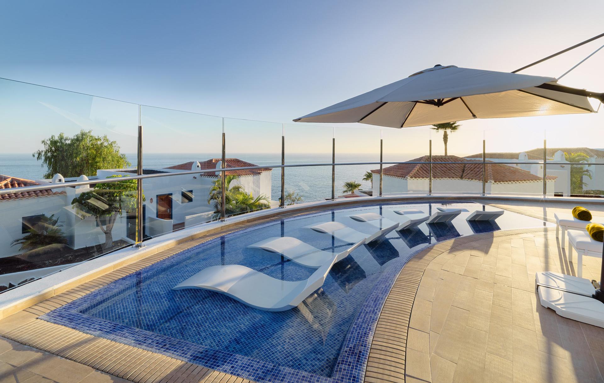 Outdoor pool with sunbeds inside part of spa facilities