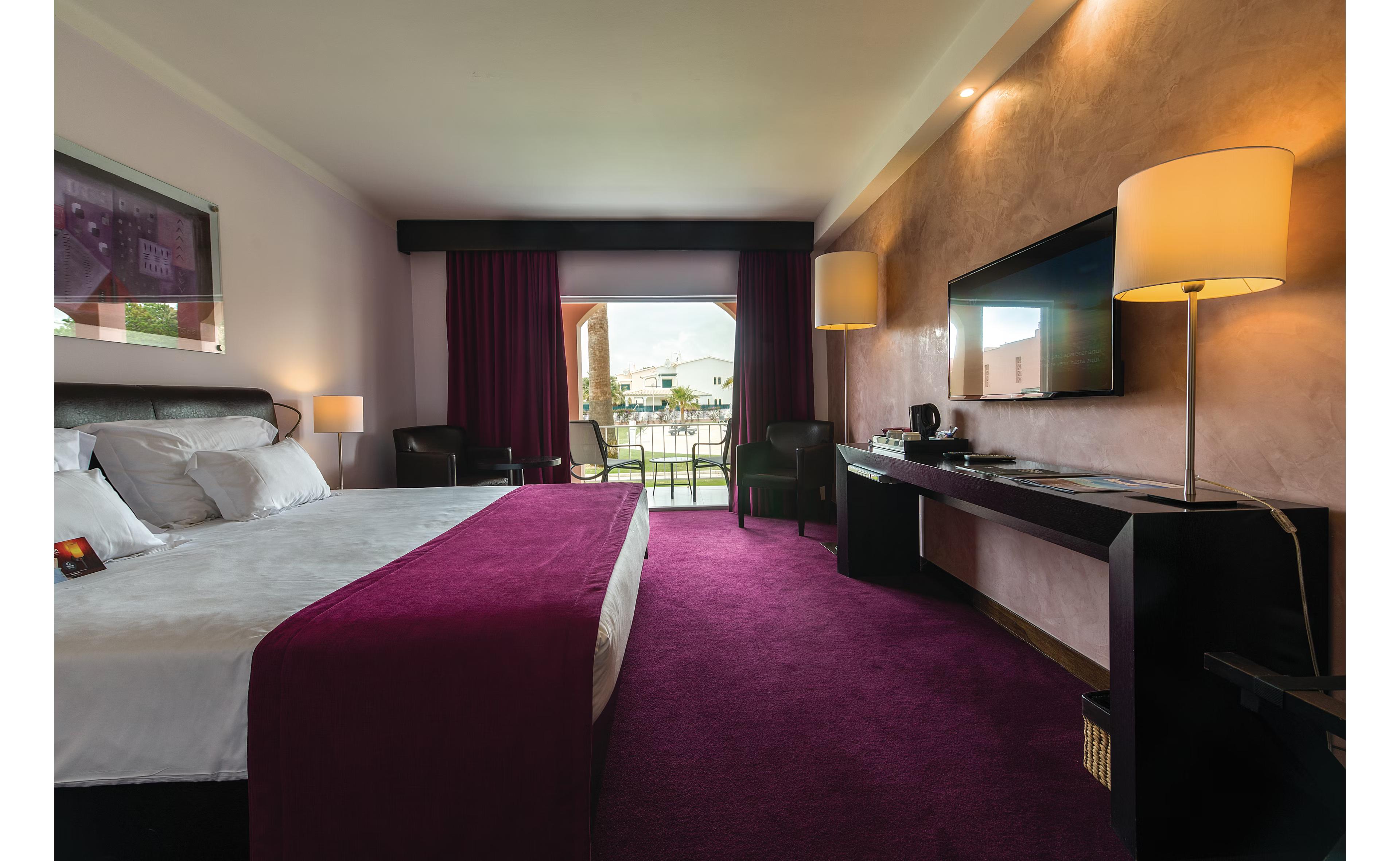 Double bed suite at Hotel Vila Gale Collection Praia following a purple colour theme