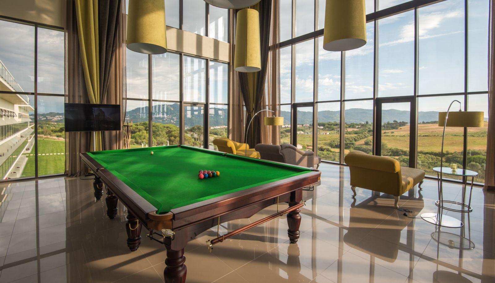 Pool table as part of lounging area with panoramic window views at Hotel Vila Gale Collection Sintra