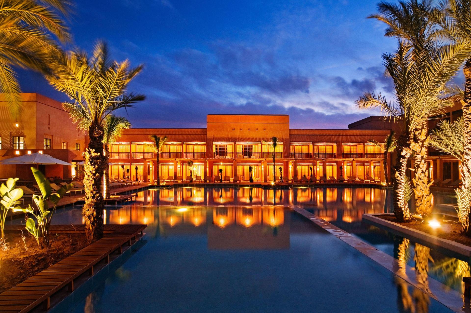 Panoramic view of the Hotel du Golf by Pickalbatros building at night overlooking the outdoor pool