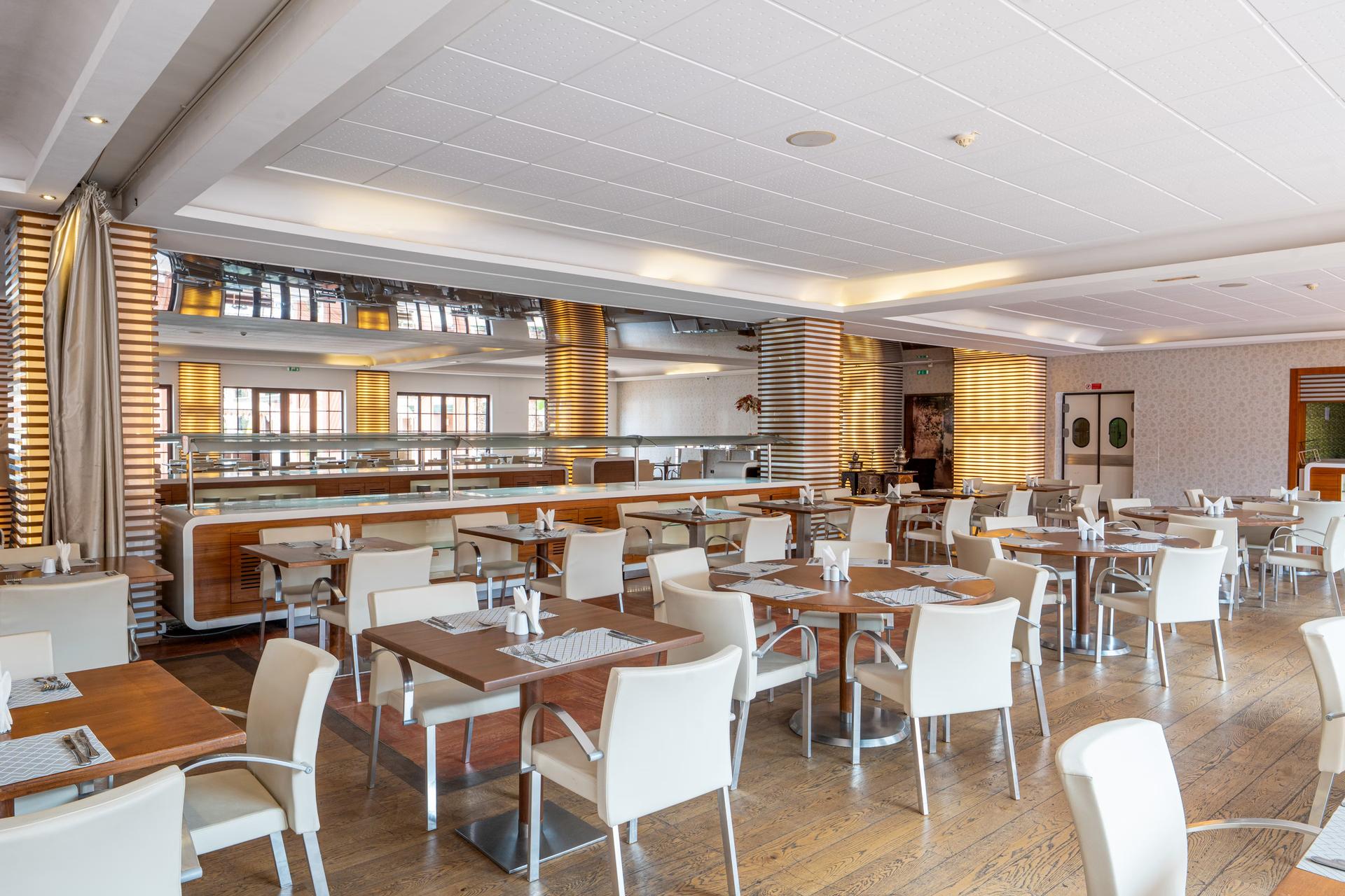 Indoor dining area at Hotel du Golf by Pickalbatros
