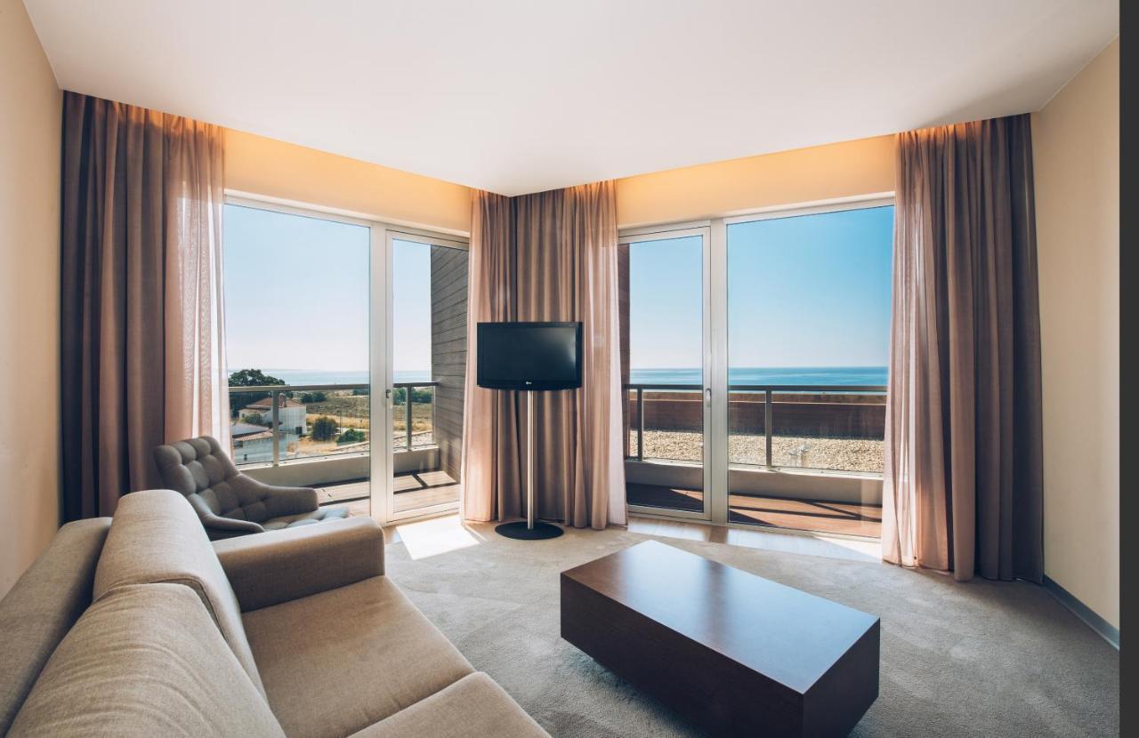 Living room as pat of a suite with panoramic window views at Iberostar Selection Lagos Algarve