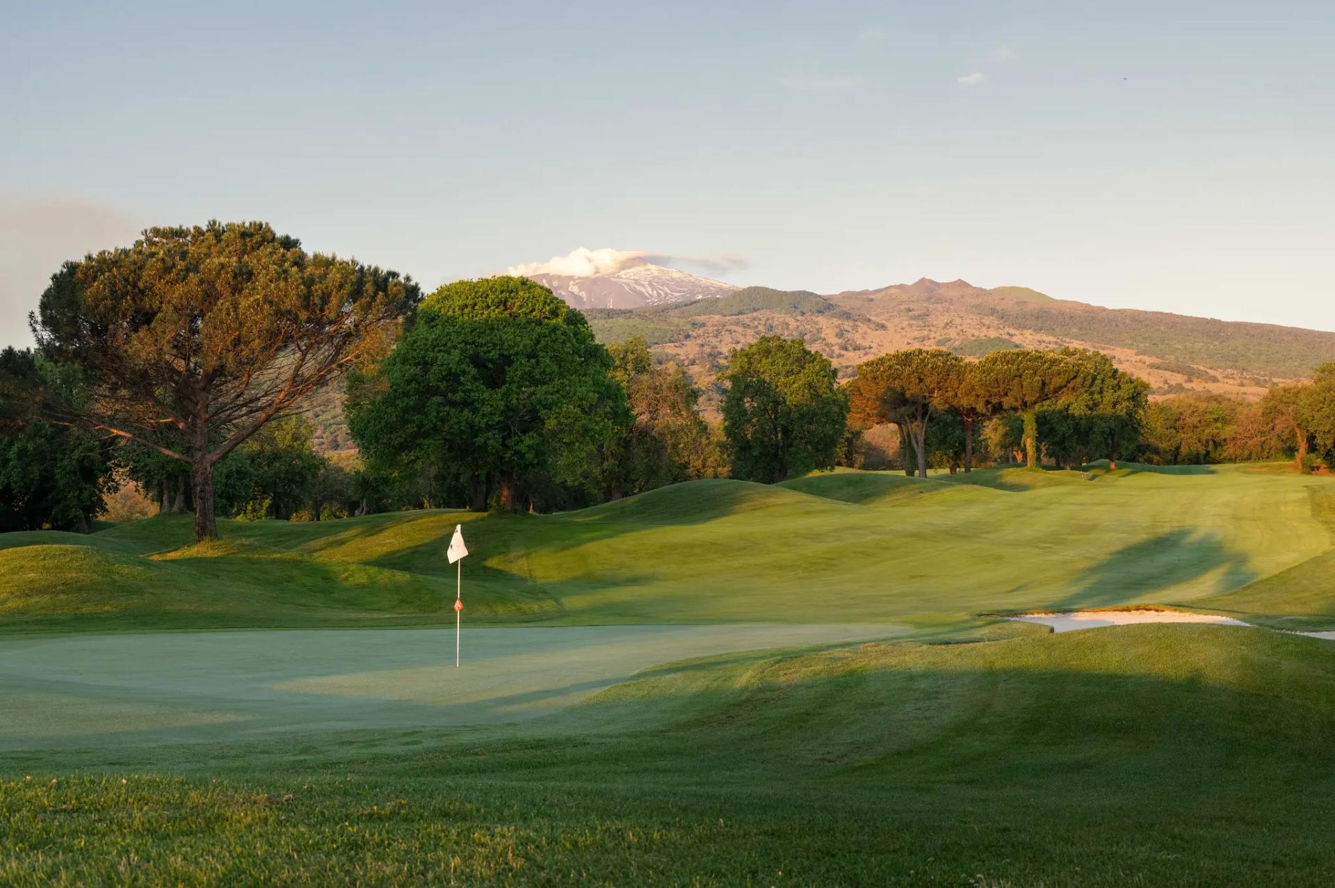 A well maintained fairway leading to a smooth green at Il Picciolo Etna Golf Resort & Spa, Curio Collection by Hilton