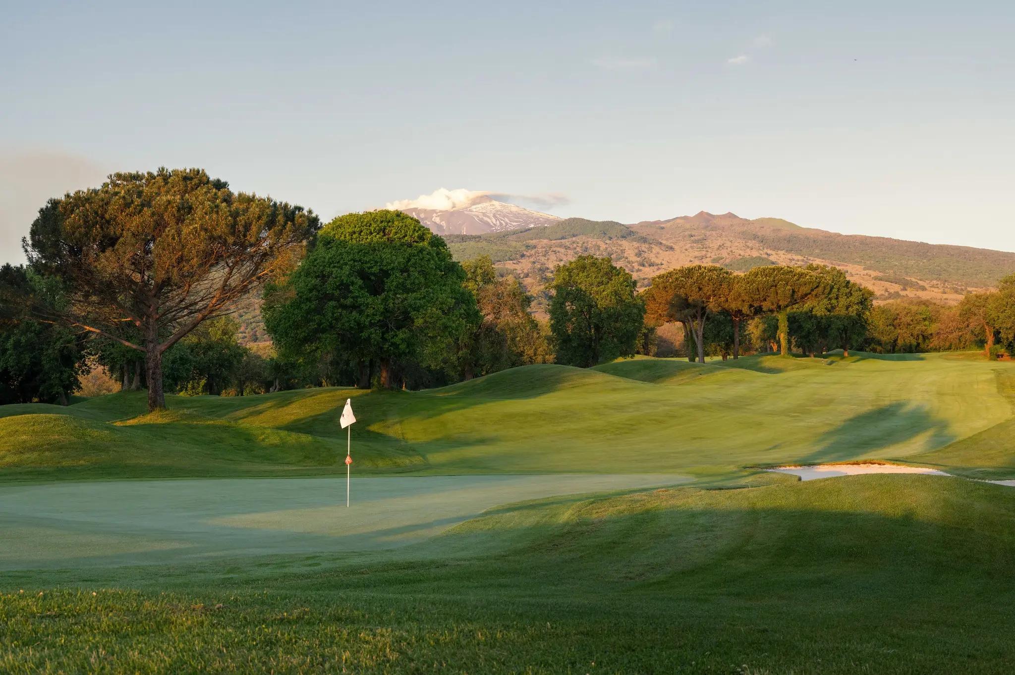 A well maintained fairway leading to a smooth green at Il Picciolo Etna Golf Resort & Spa, Curio Collection by Hilton