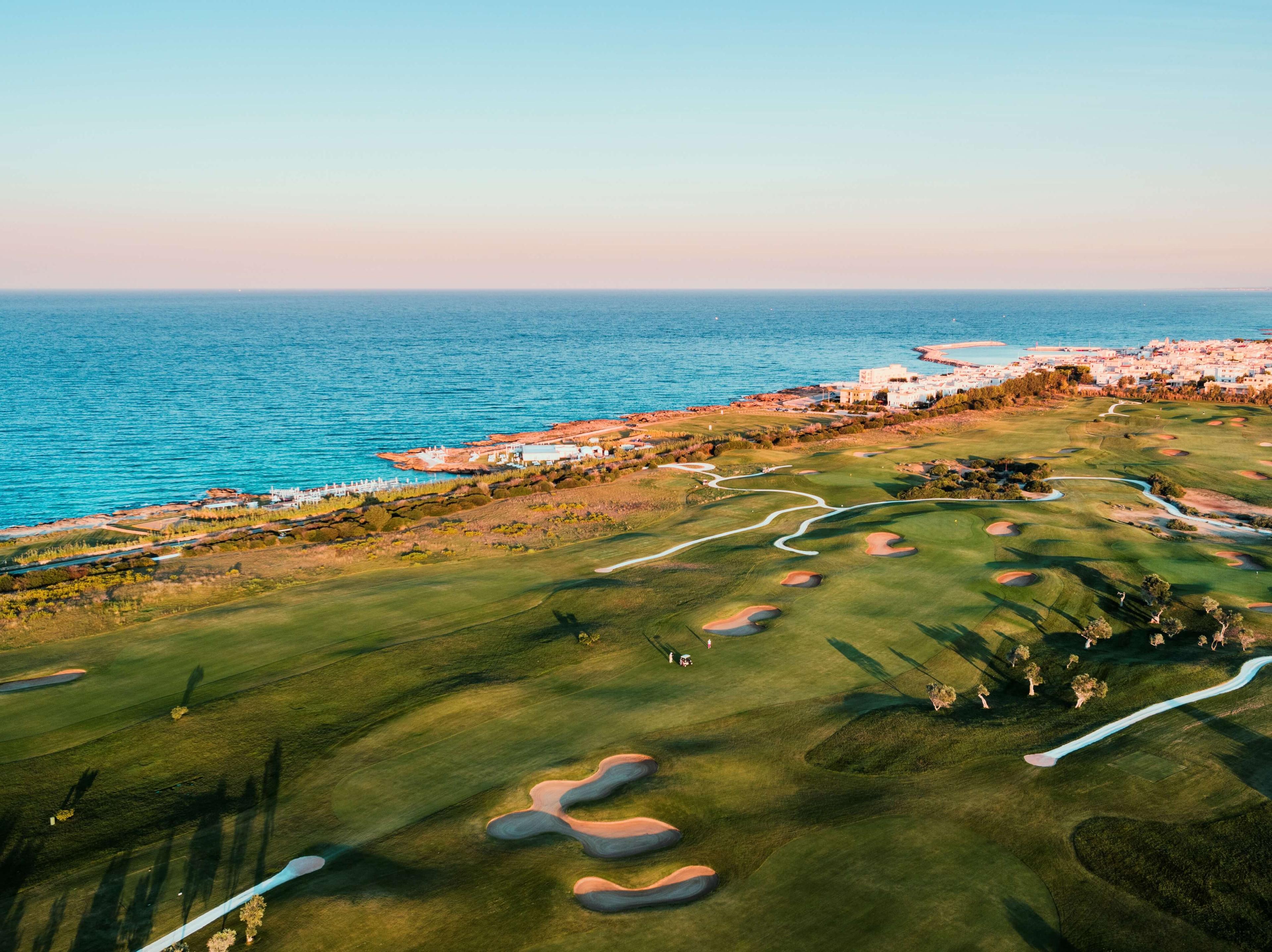 Aerial view of a coastal fairway nestled with sand bunkers