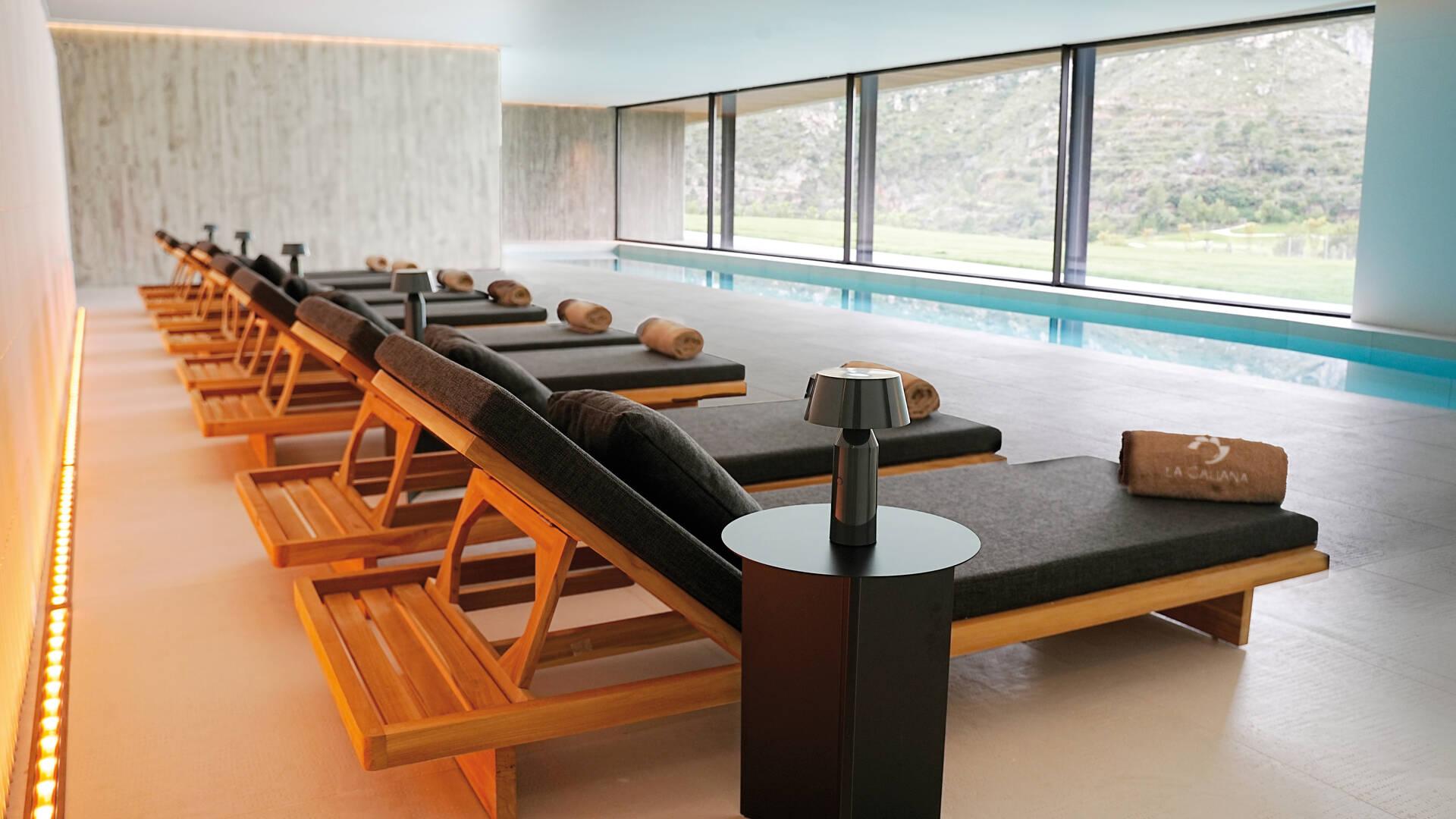 Indoor pool at La Galiana Golf Resort lined with sunbeds