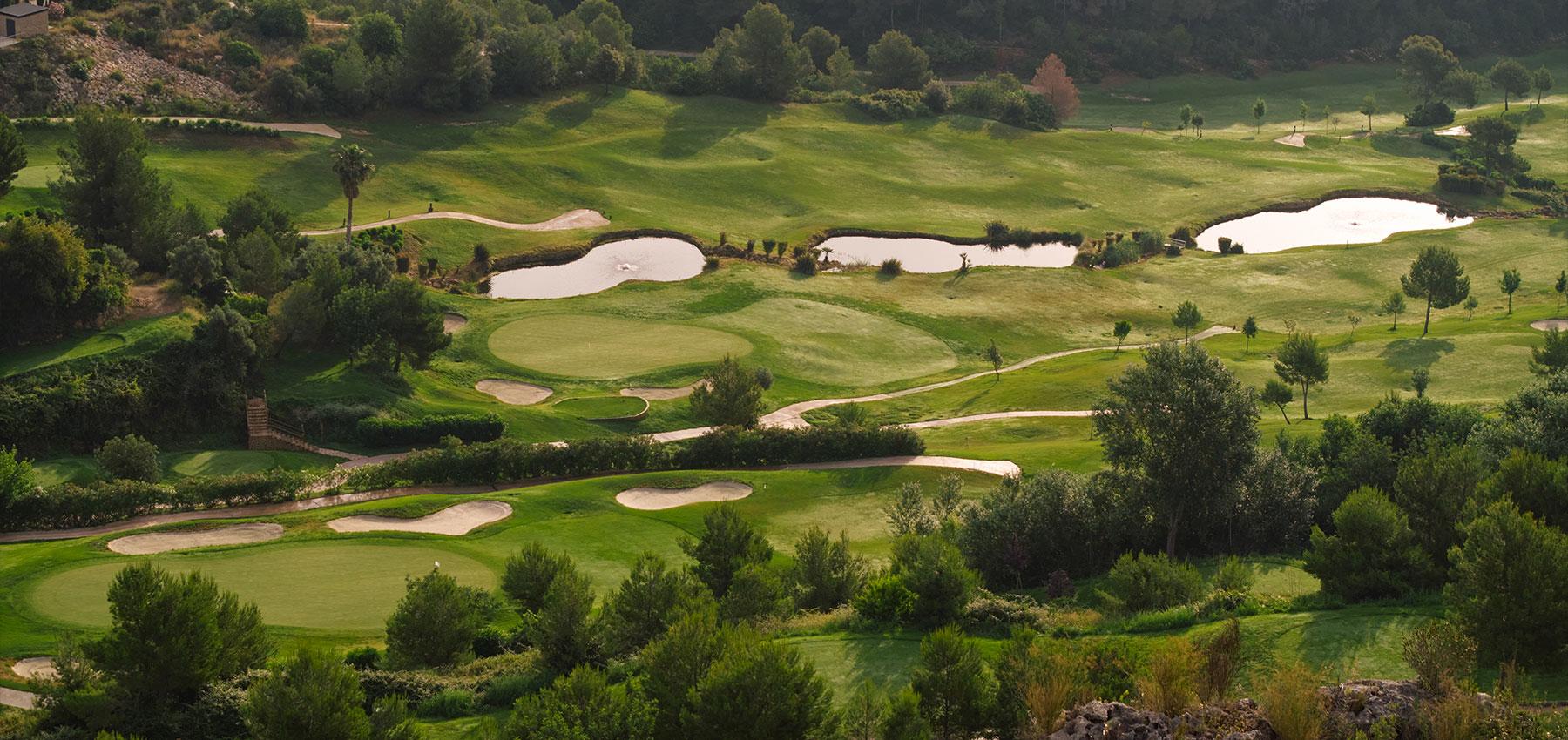 Aerial view of a well maintained fairway nestled with sand bunkers at La Galiana Golf Resort