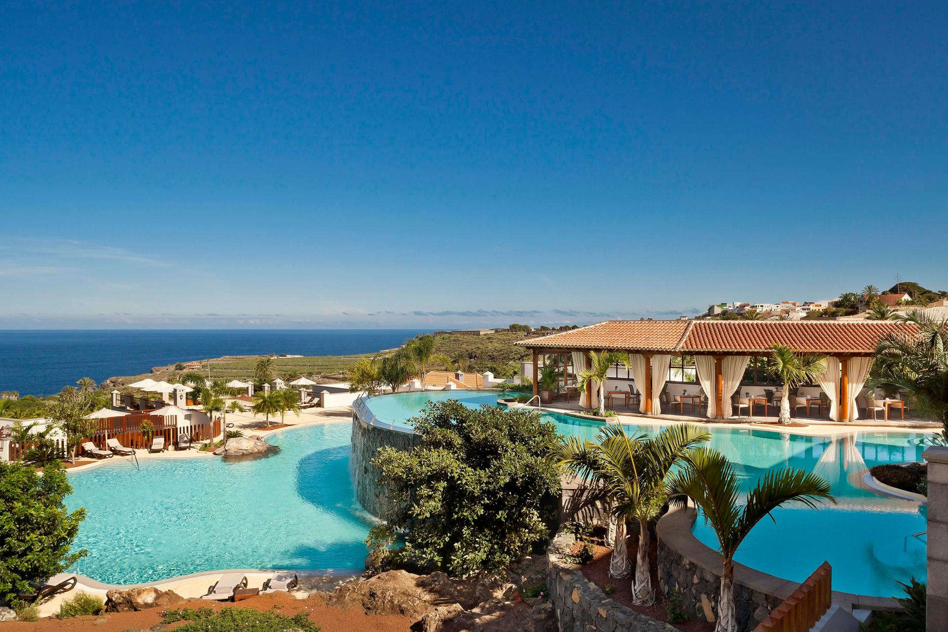 Panoramic view of the outdoor swimming pool with coastal views
