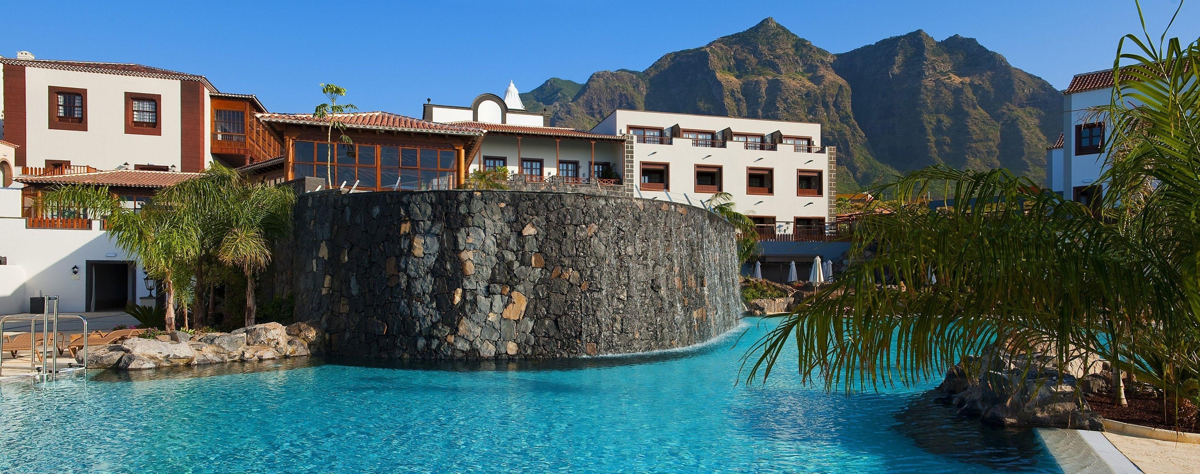 Panoramic view of the outdoor pool featuring a water fall at Melia Hacienda Del Conde