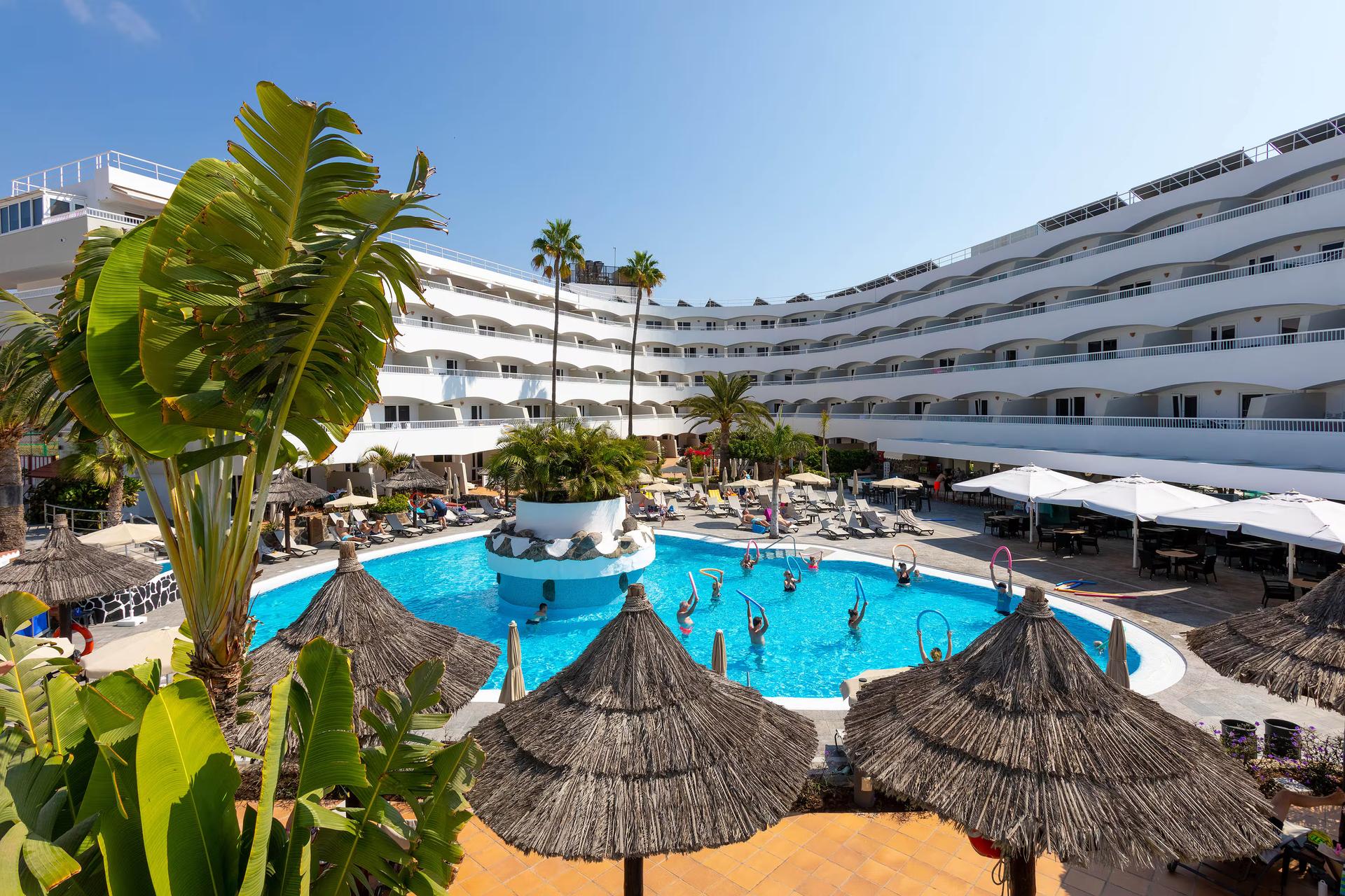 Panoramic view of the Melia Sol Barbacan building overlooking the outdoor pool