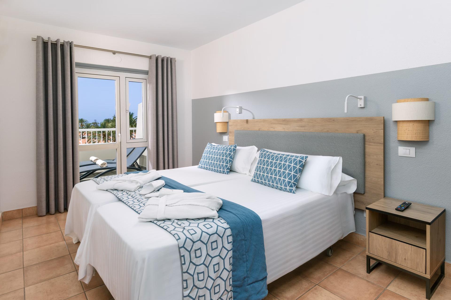 Double bed suite with balcony views at Melia Sol Barbacan