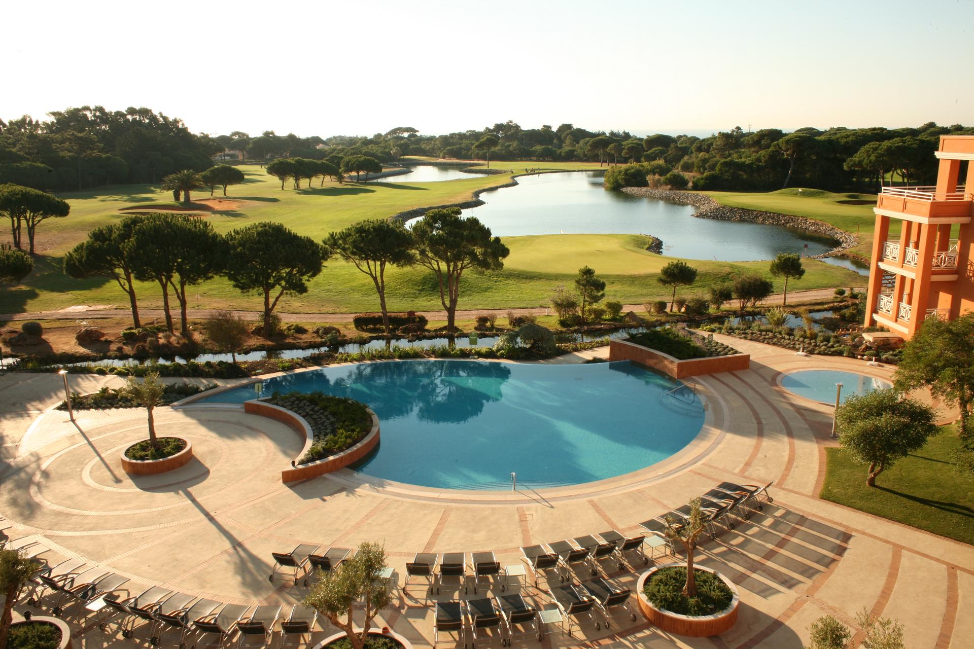 Overhead view of the outdoor swimming pool with views of the course at Montado Hotel & Golf Resort