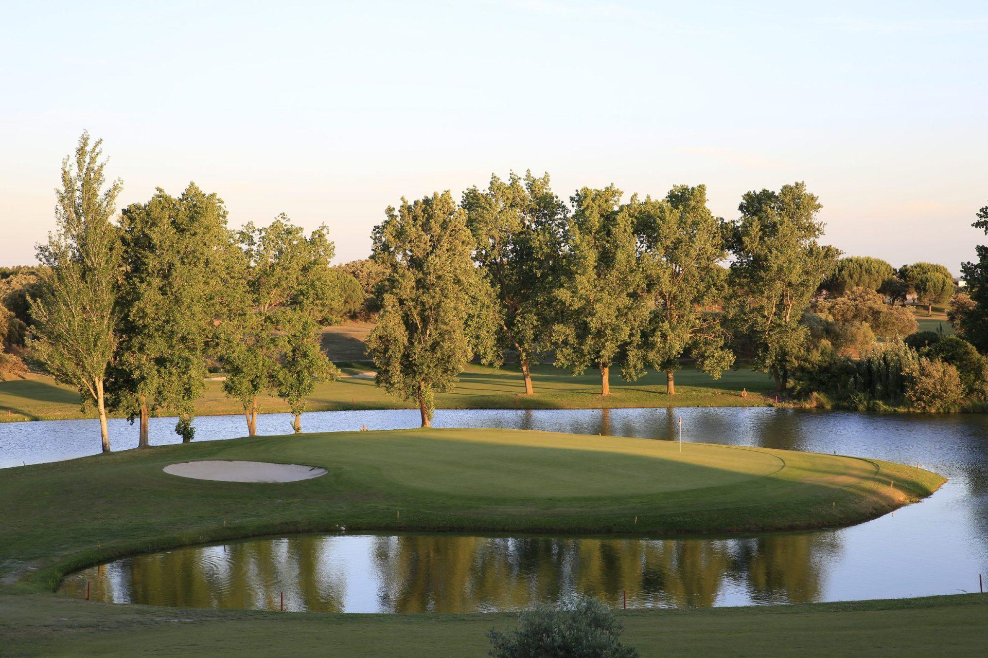 An island green nestled with a sand bunker on the Montado Hotel & Golf Resort golf course