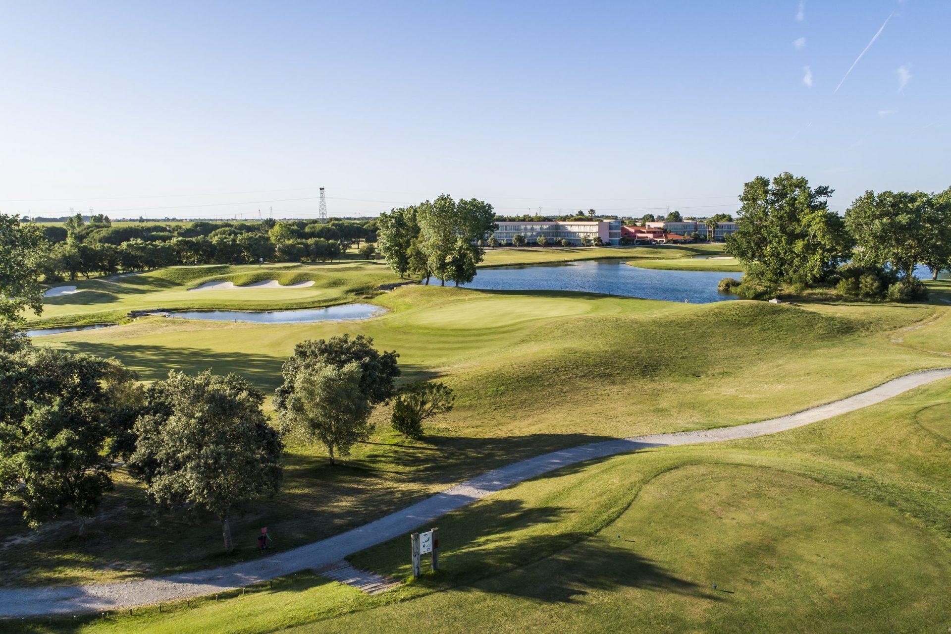 A well maintained fairway next to water hazards at Montado Hotel & Golf Resort