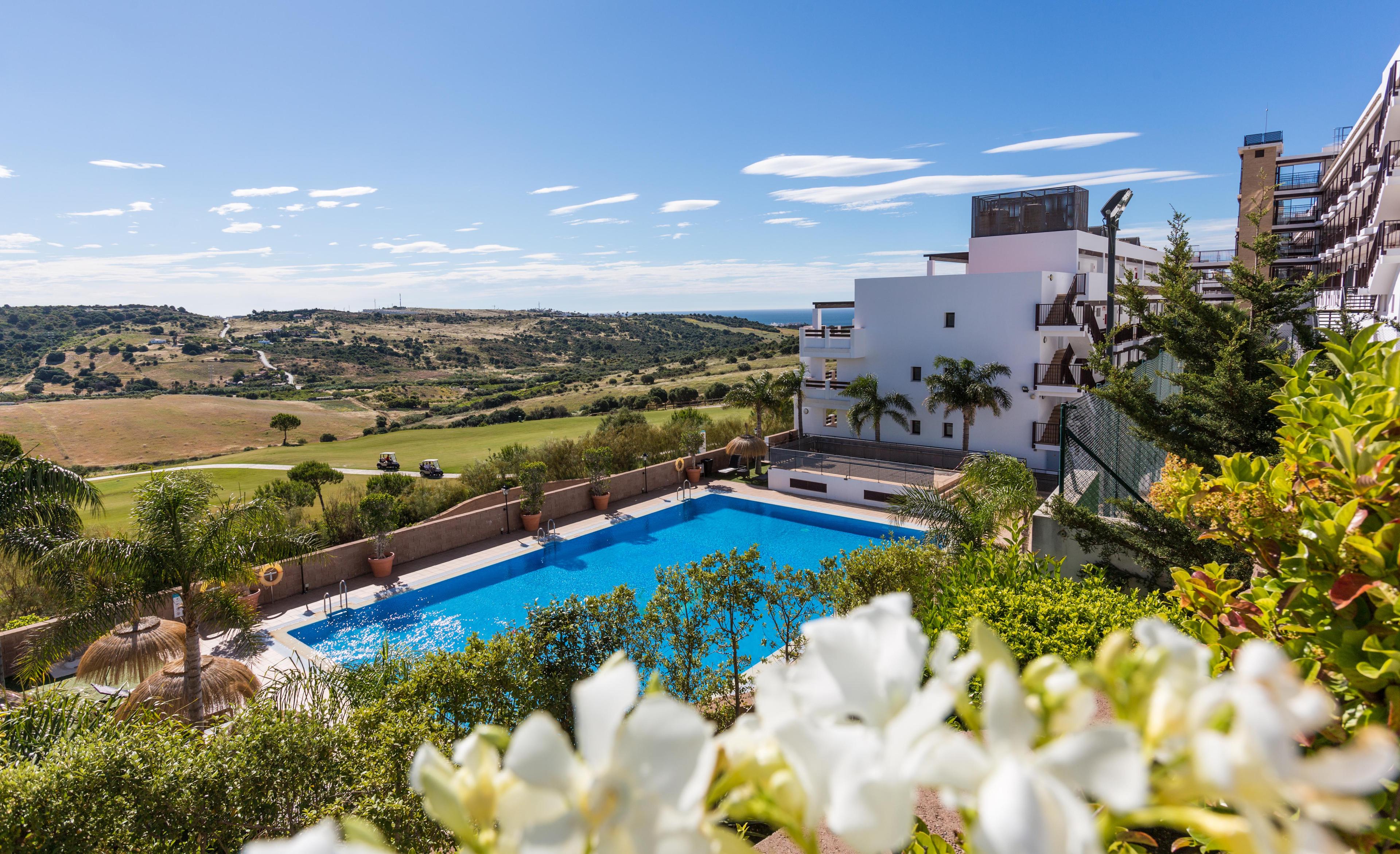 Overhead view of outdoor pool and golf course at ONA Valle Romano Golf Resort