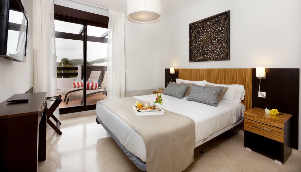 Double bed suite at ONA Valle Romano Golf Resort with balcony views