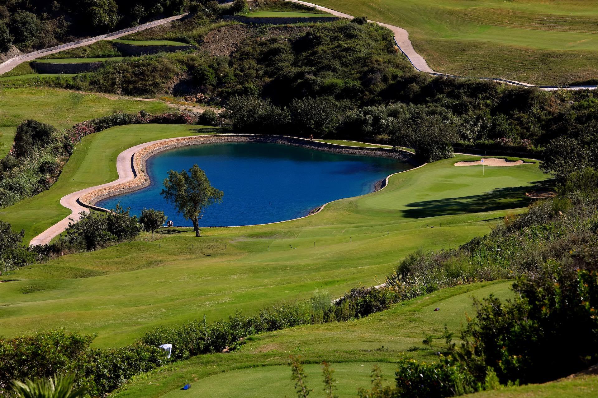 Overhead view of a well maintained fairway with a water hazard