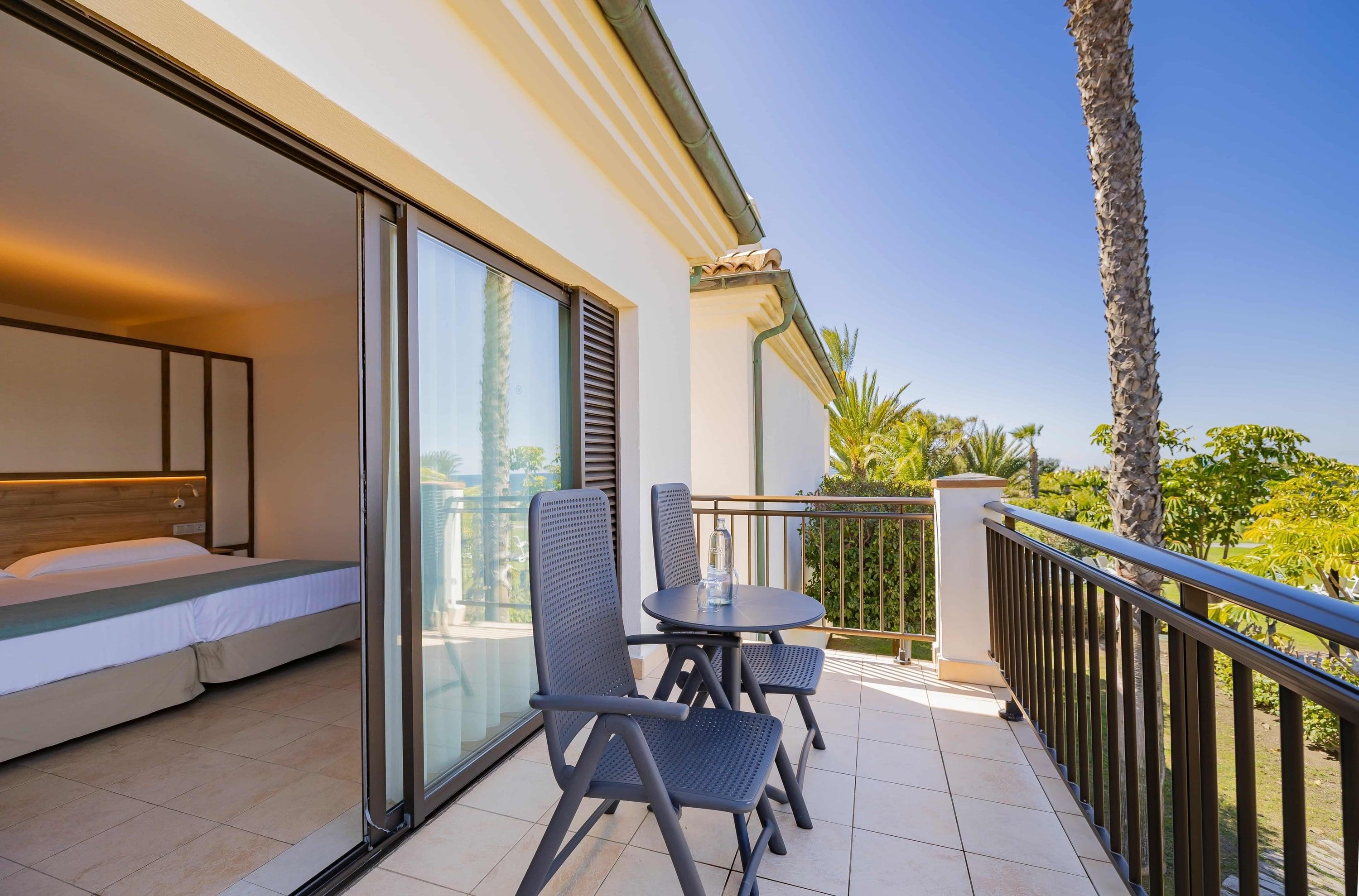 Double bed suite leading to a balcony at Playa Granada Club Resort & Spa