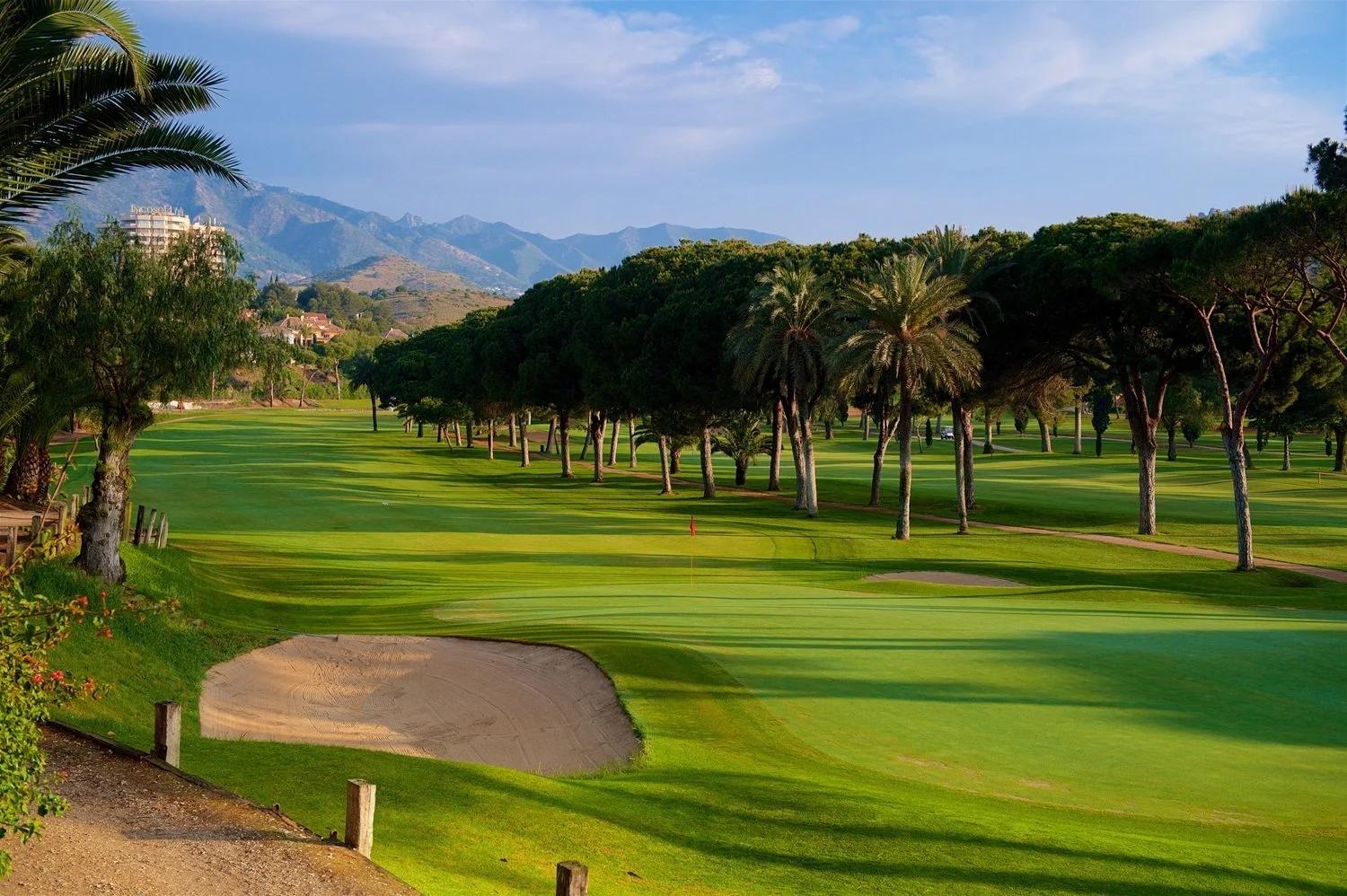 Panoramic view of a well maintained fairway nestled with sand bunkers