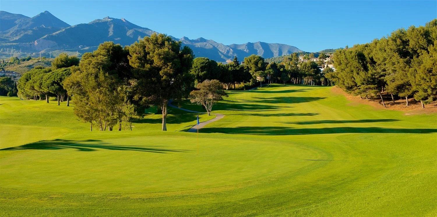 A well maintained fairway with mountain views in the distance