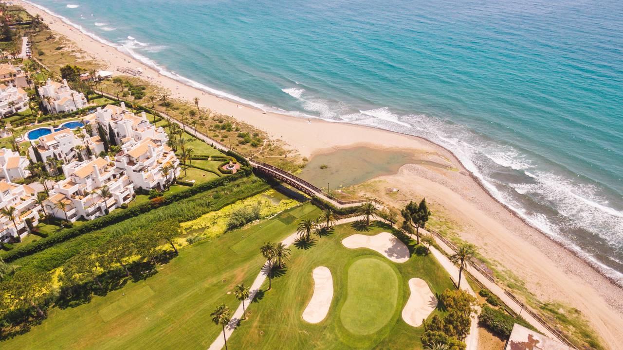 Aerial view of a smooth green surrounded by sand bunkers
