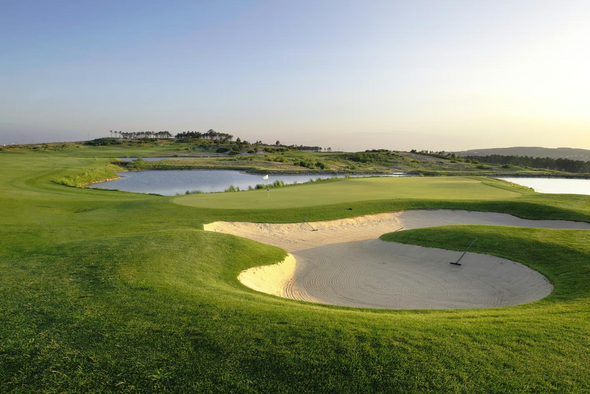 A smooth green next to a sand bunker