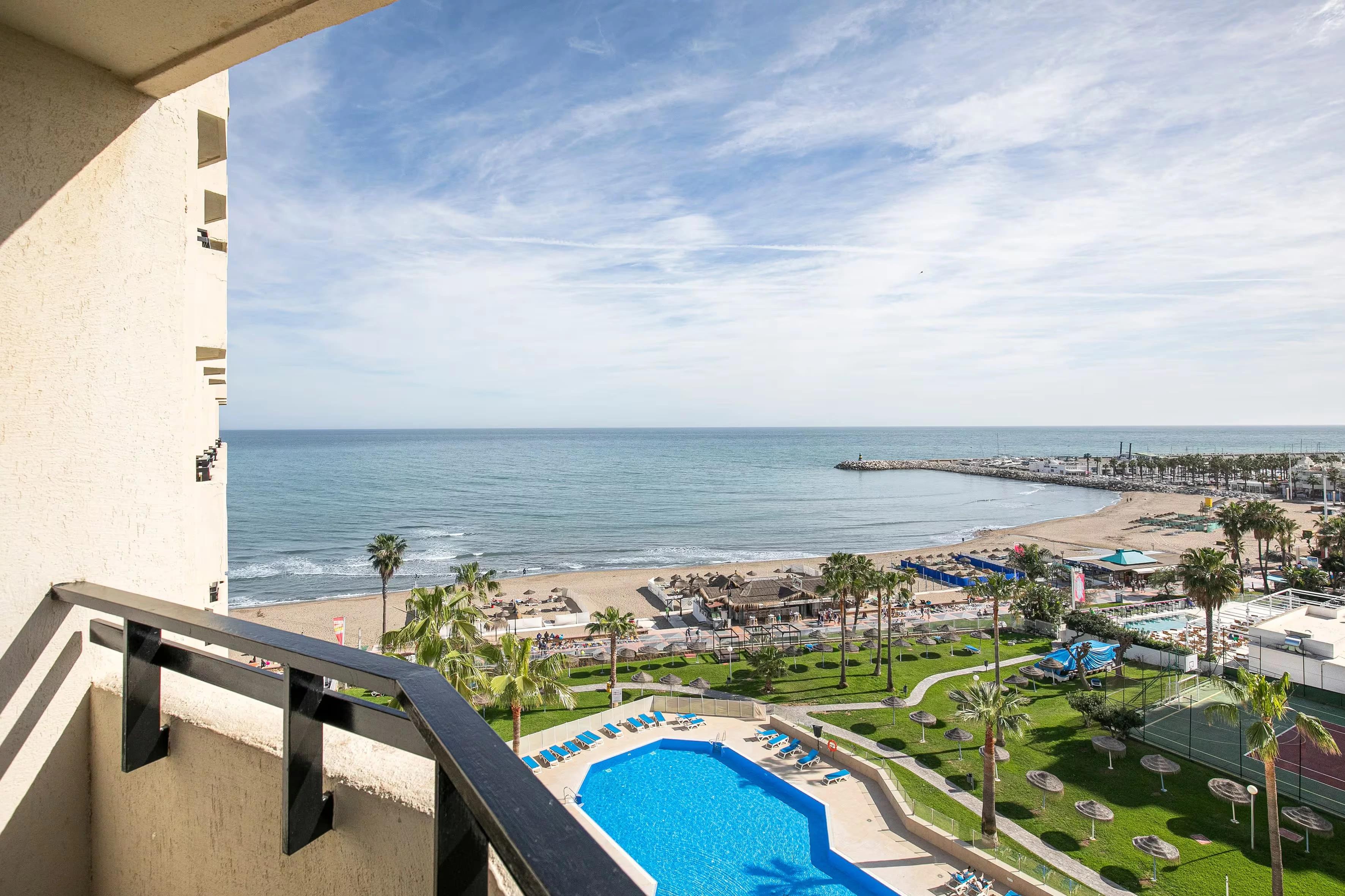 Balcony views of the coast and outdoor swimming pool at Sol Timor Apartamentos
