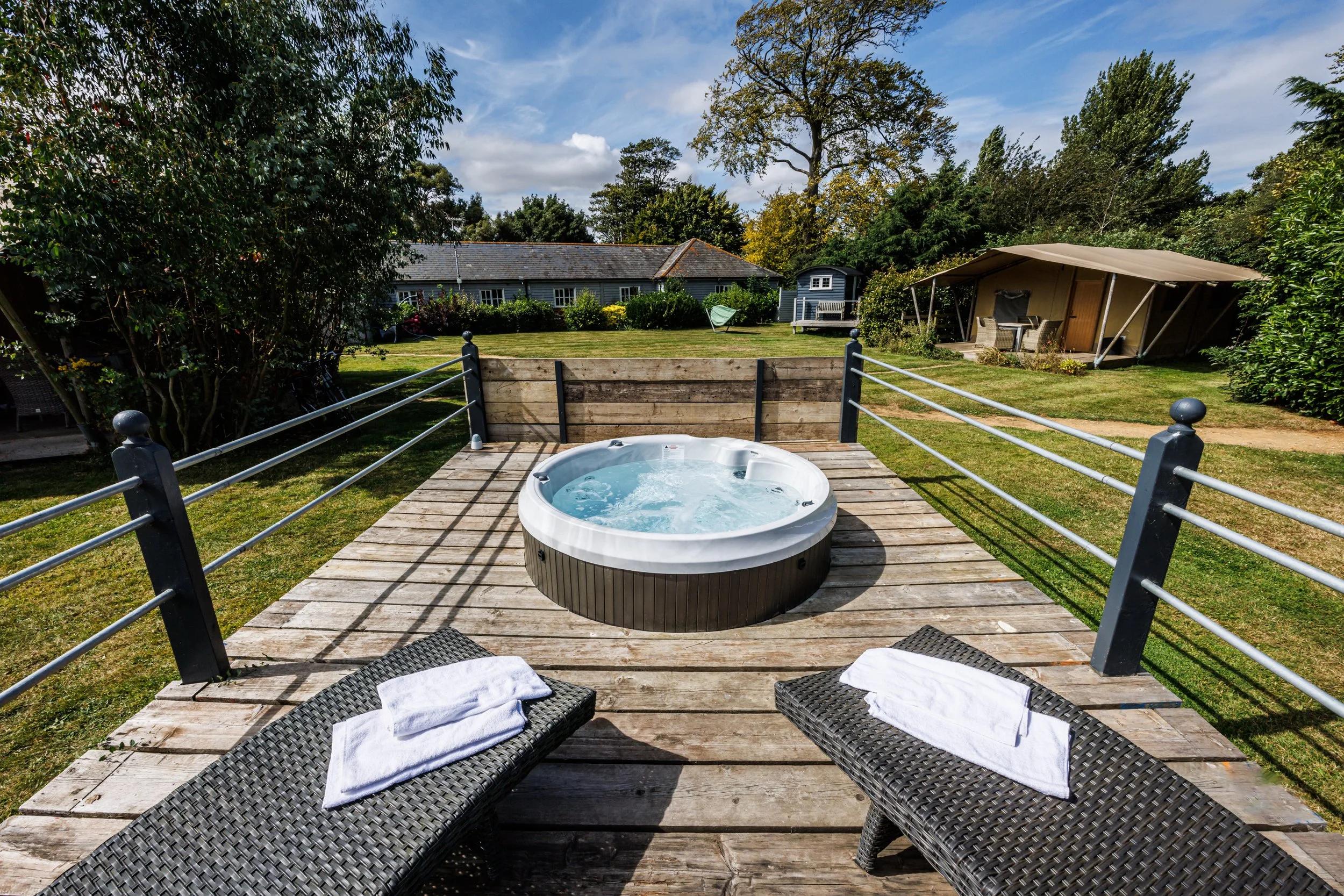 Outdoor jacuzzi with two sunbeds