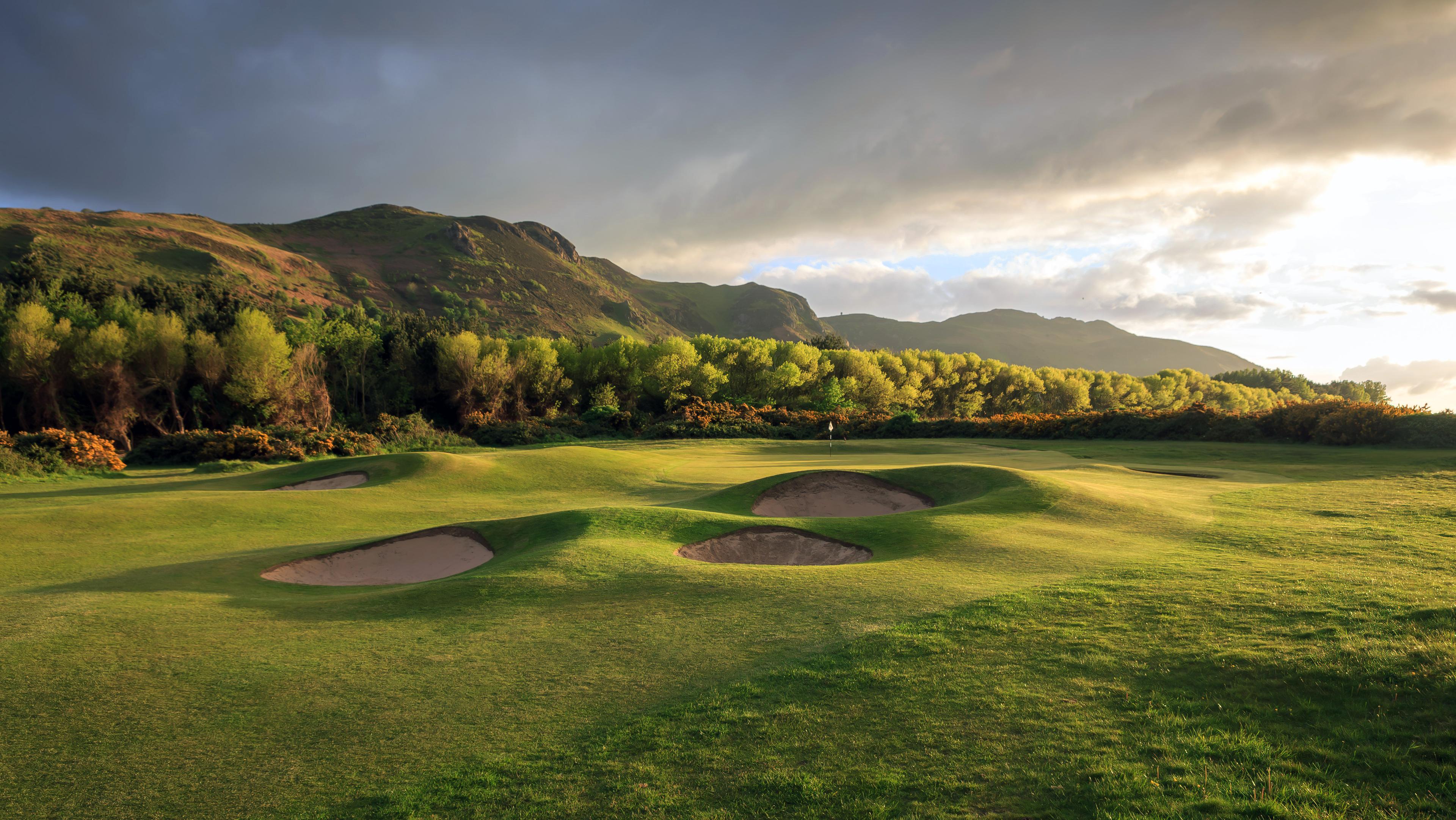 Panoramic view of a well maintained fairway nestled with sand bunkers